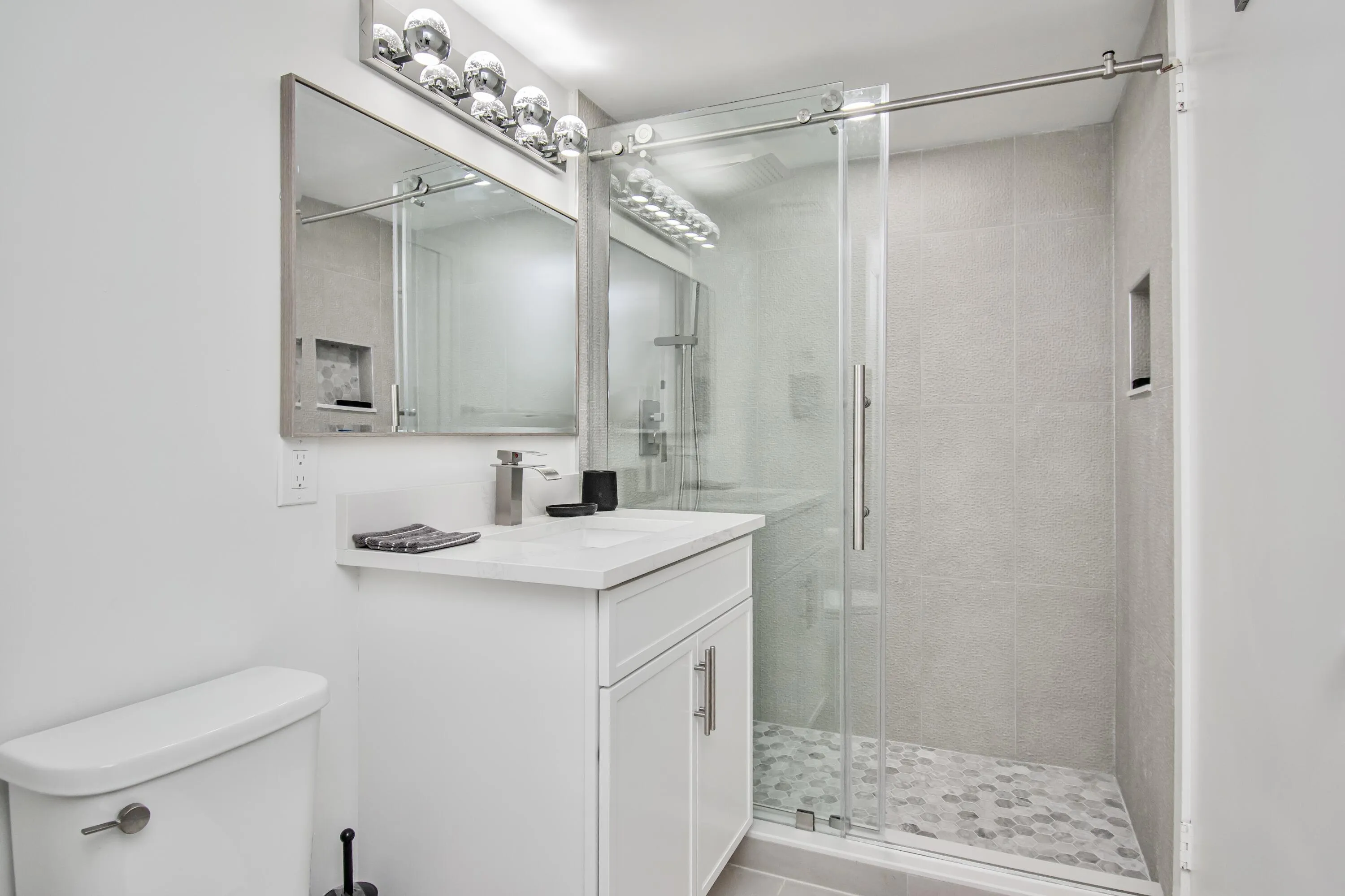 Bathroom vanity with a solid surface countertop and the most fabulous shower