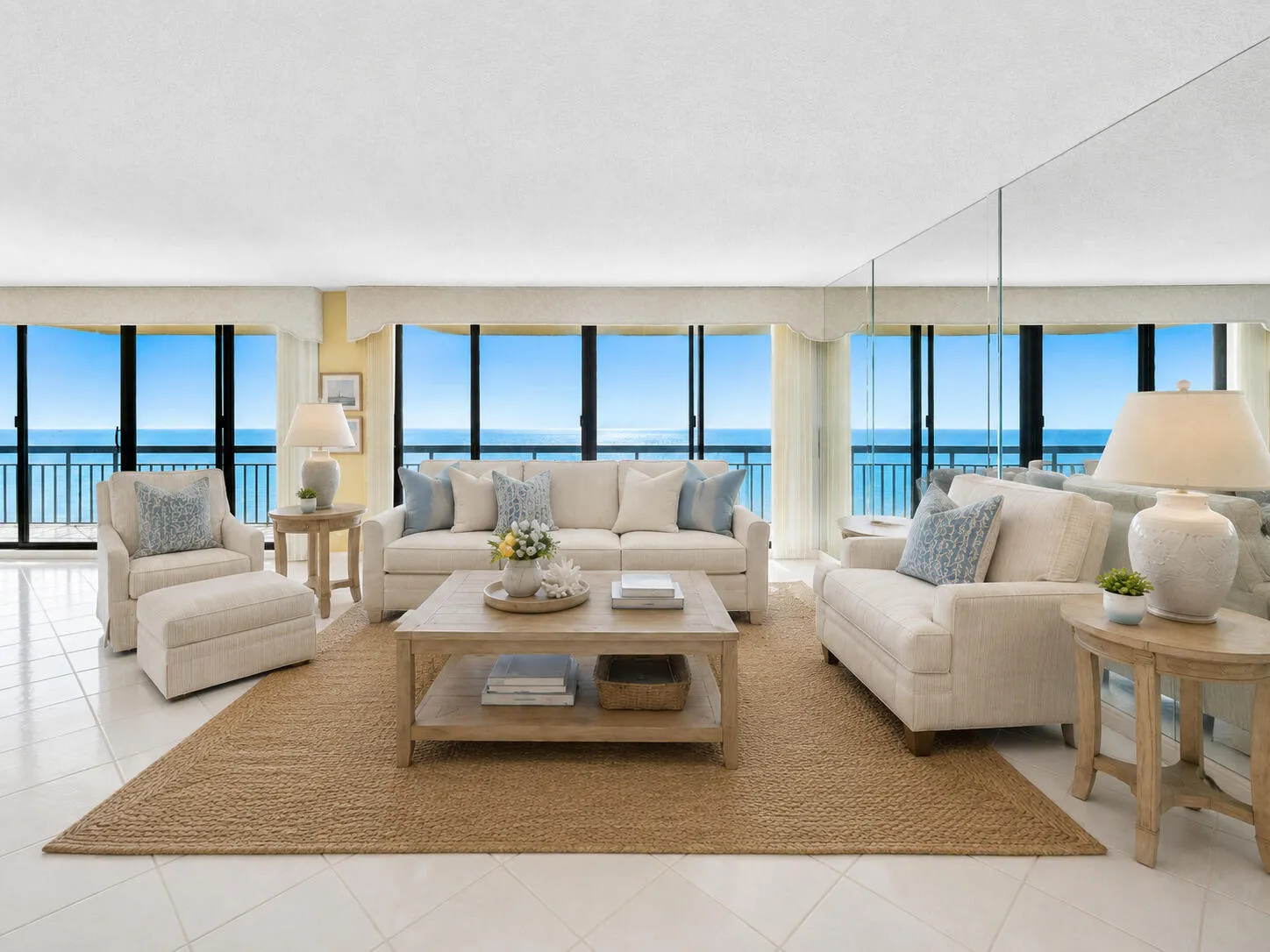Walls of glass frame direct Atlantic views from the expansive living room. Virtually staged; furnishings and décor are digitally added and are not included.