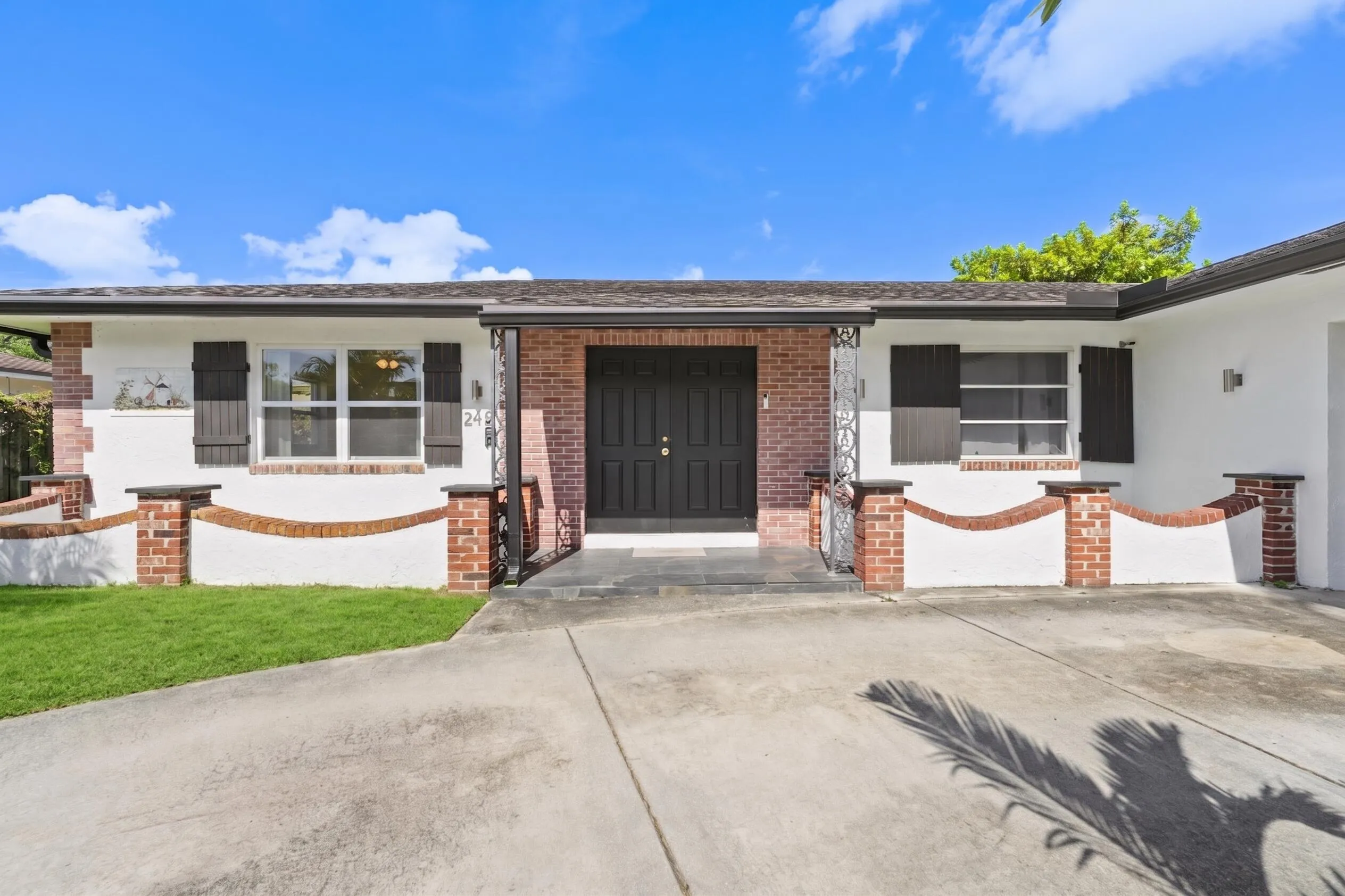 Brick and stucco exterior with dark wood shutters