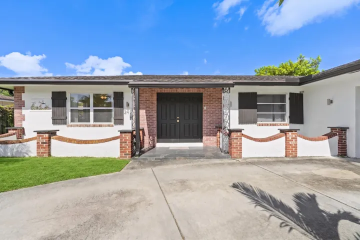 Brick and stucco exterior with dark wood shutters