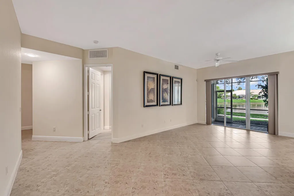 formal living room leading to hallway, primary bedroom, patio