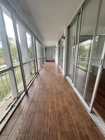 OVERSIZED TILE PATIO WITH SCREEN OVERLOOKING THE POOL