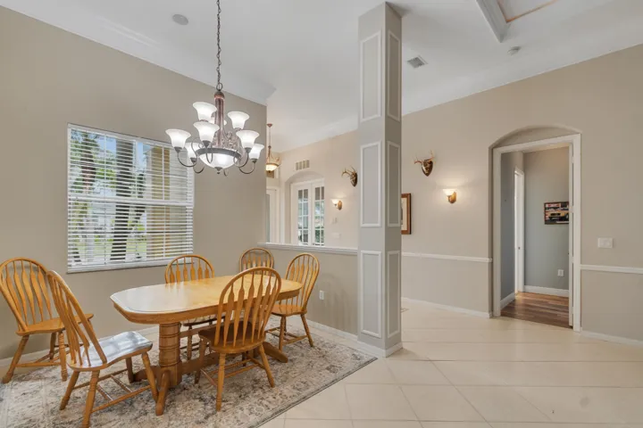 Dining area and pony-wall-defined vestibule/entry/foyer.