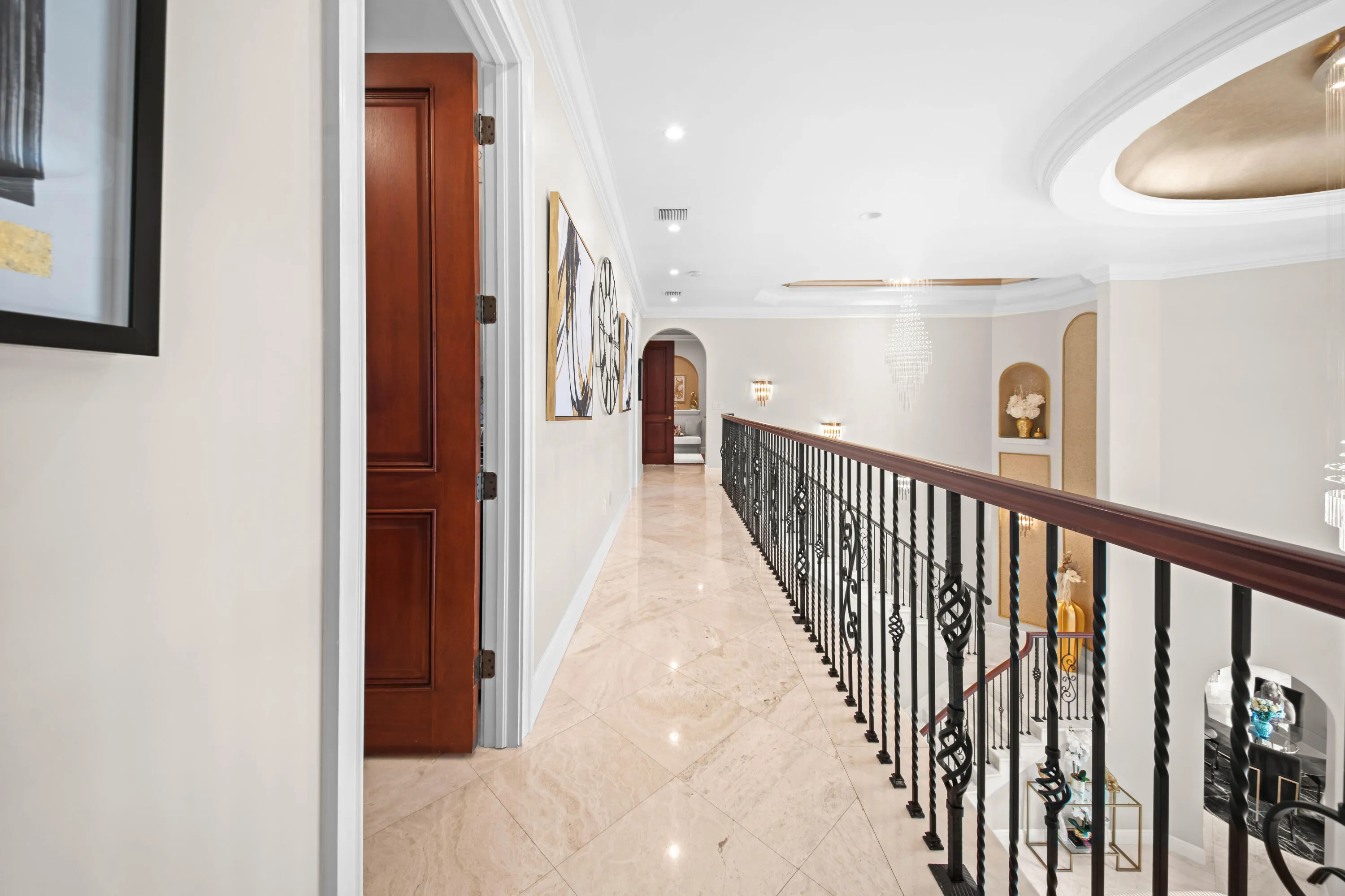 Upper Level Gallery Walkway with Grand Overlook of living area and chandeliers