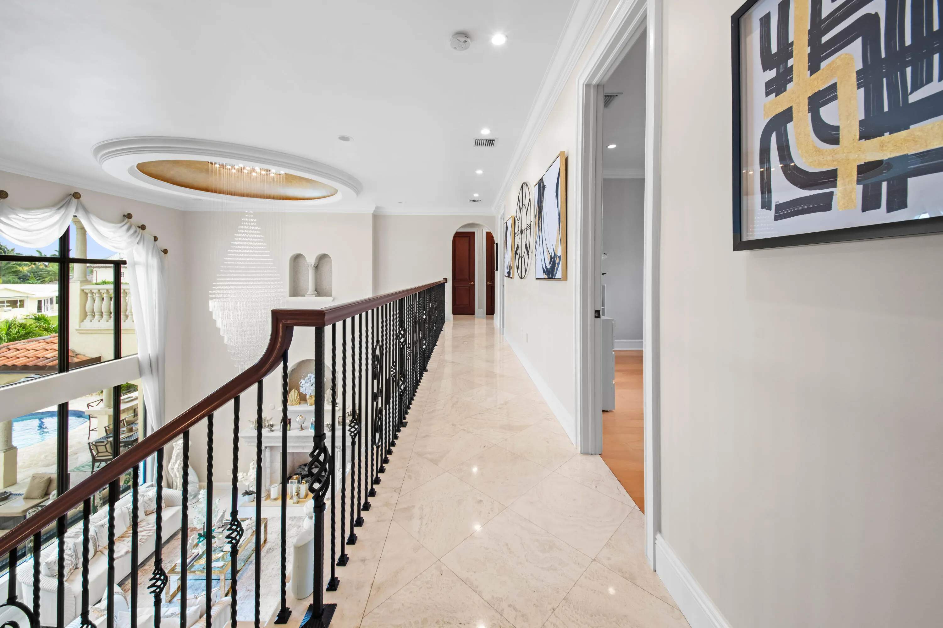 Upper Level Gallery Walkway with Grand Overlook of living area and chandeliers
