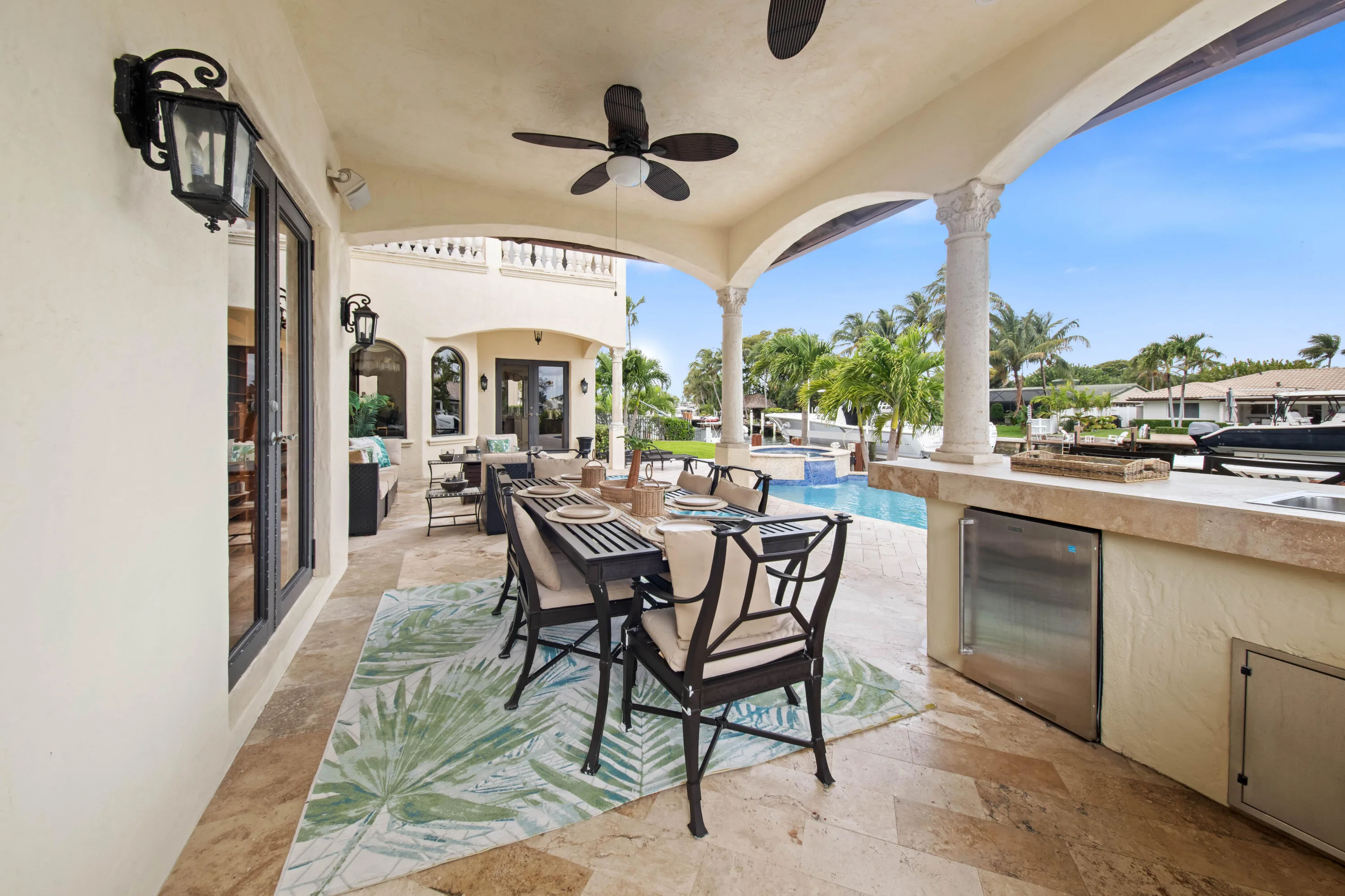 Covered Outdoor Dining with Pool and Water View