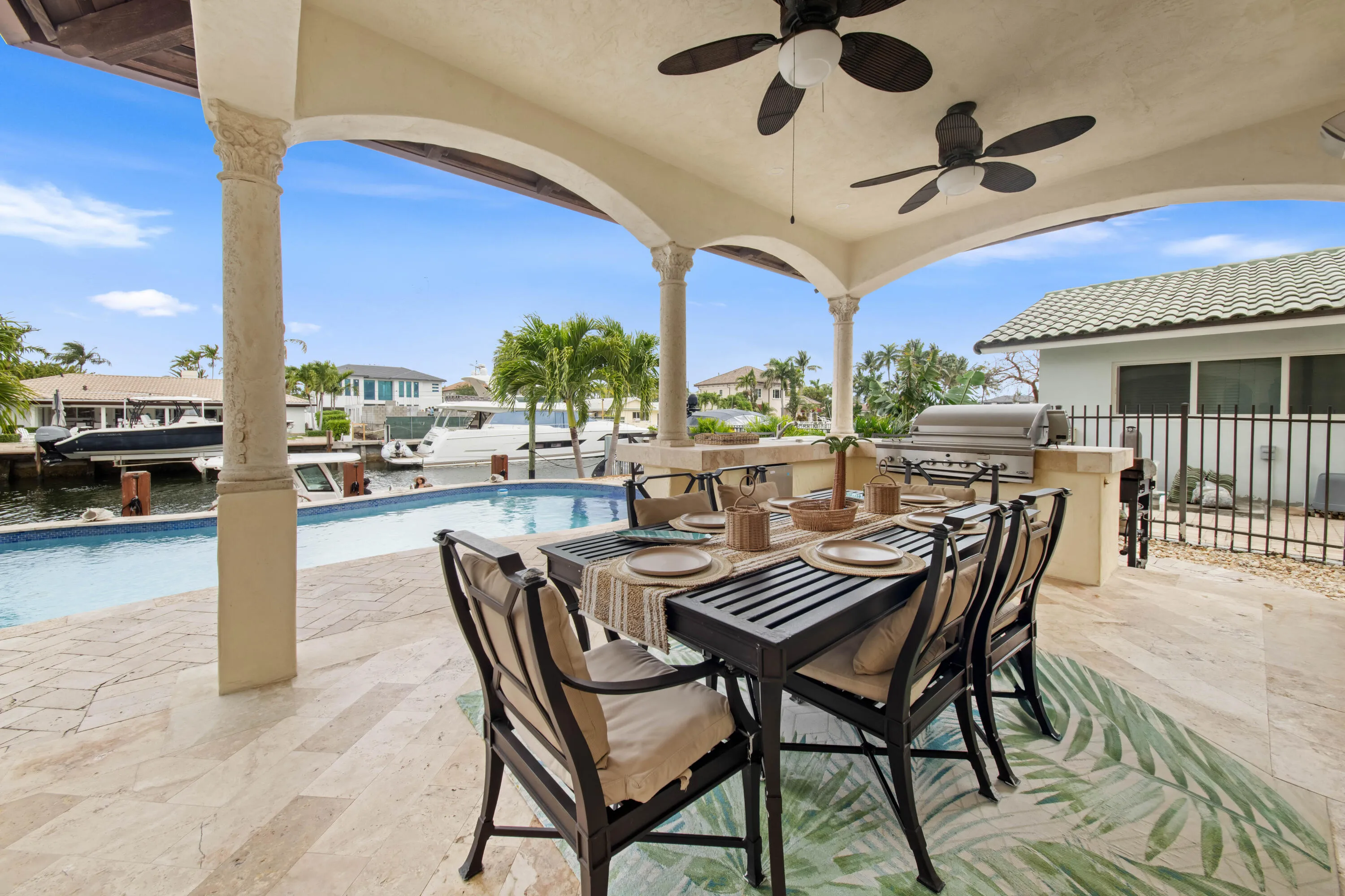 Covered Outdoor Dining with Pool and Water View