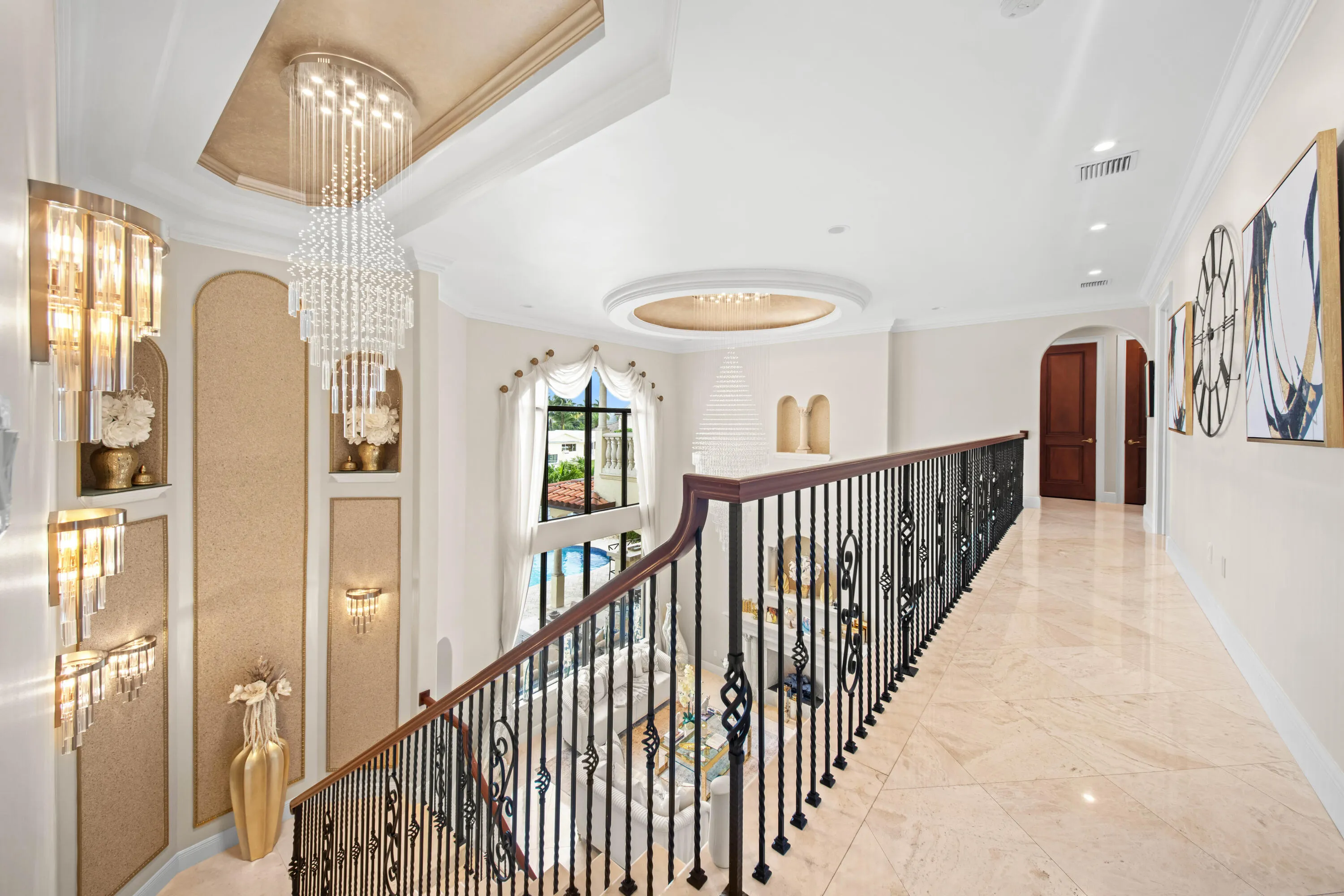 Upper Level Gallery Walkway with Grand Overlook of living area and chandeliers