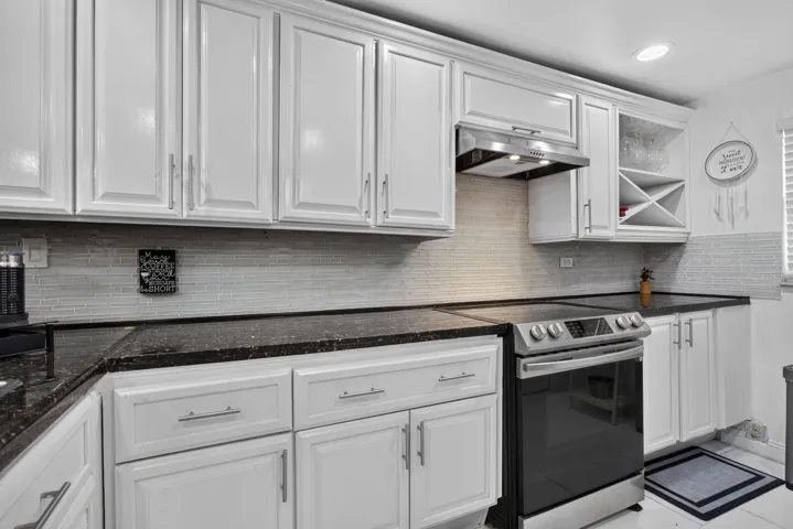 PLENTY OF CUSTOM CABINETRY FOR STORAGE NEEDS AND BUILT-IN WINE RACK