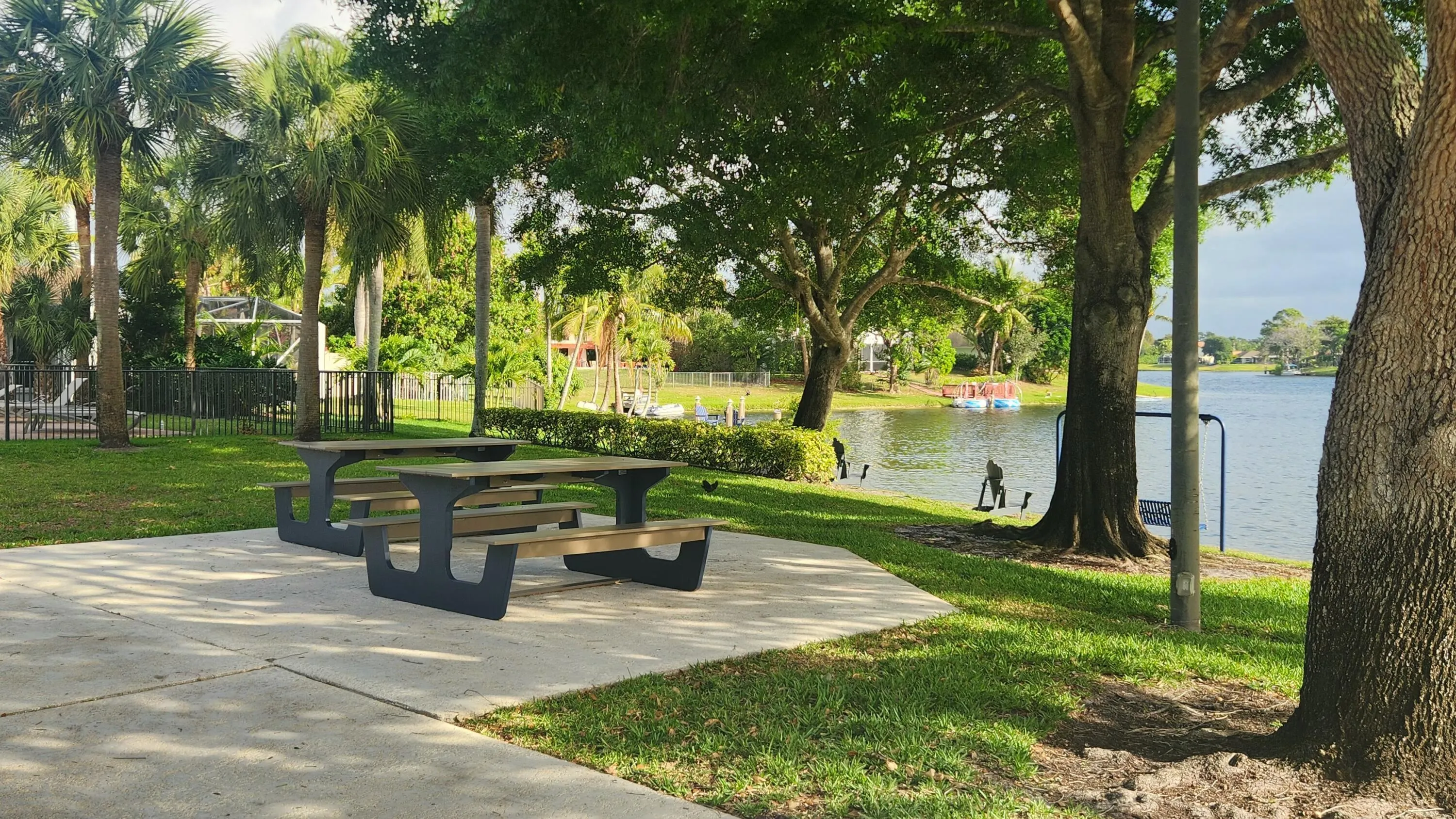 Lakeside setting with mature trees and a manicured lawn
