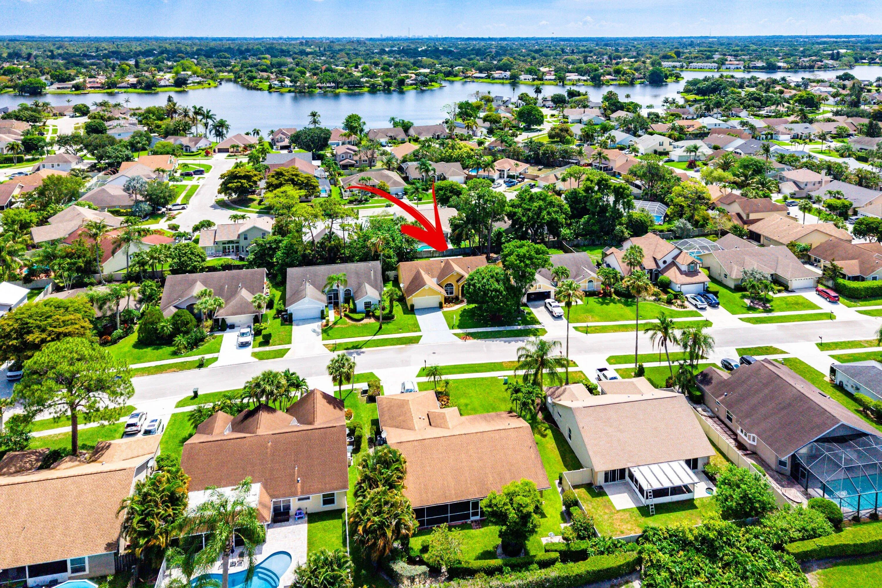 Aerial perspective of a residential neighborhood with surrounding water features