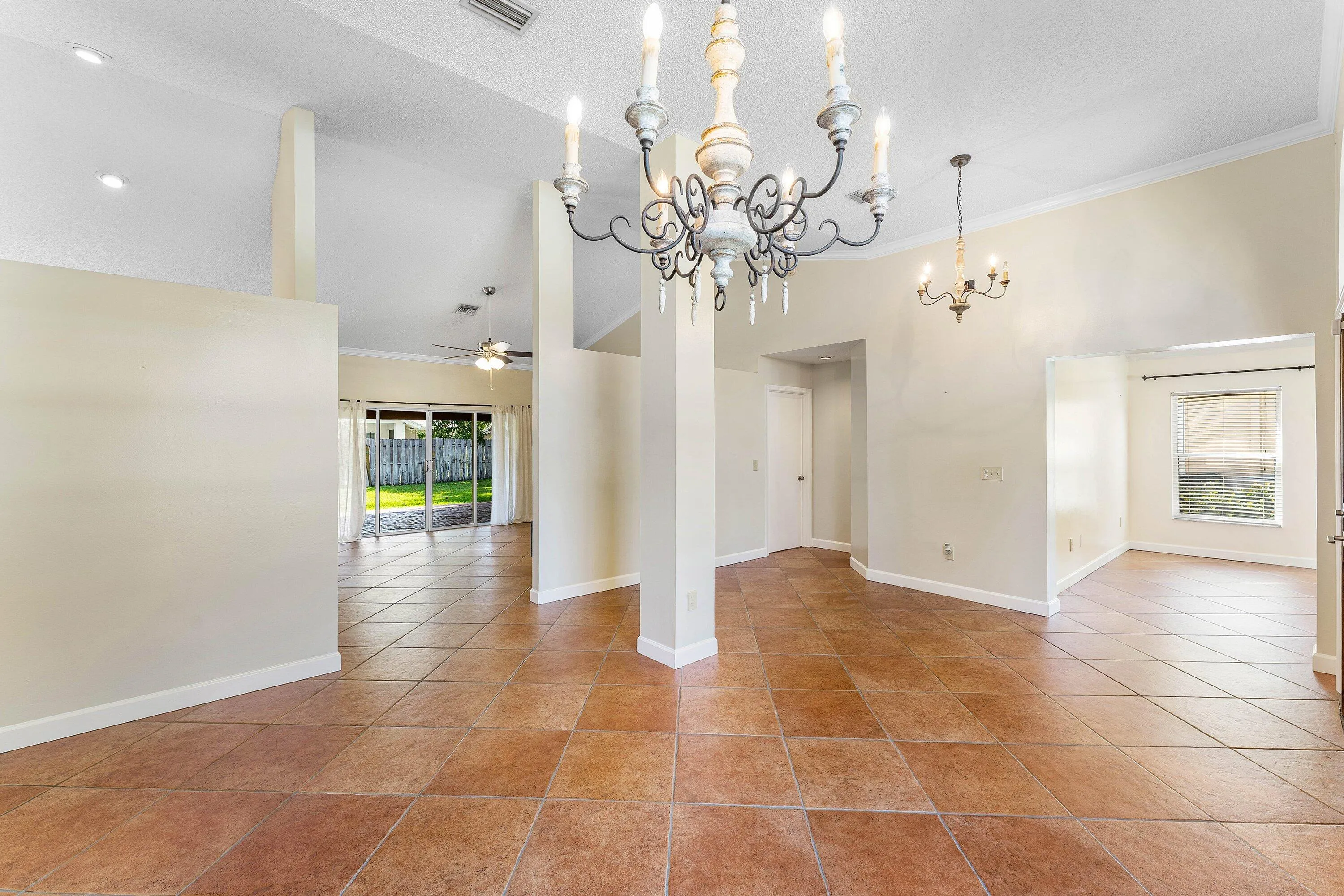Tile flooring, vaulted ceilings, and dual chandeliers