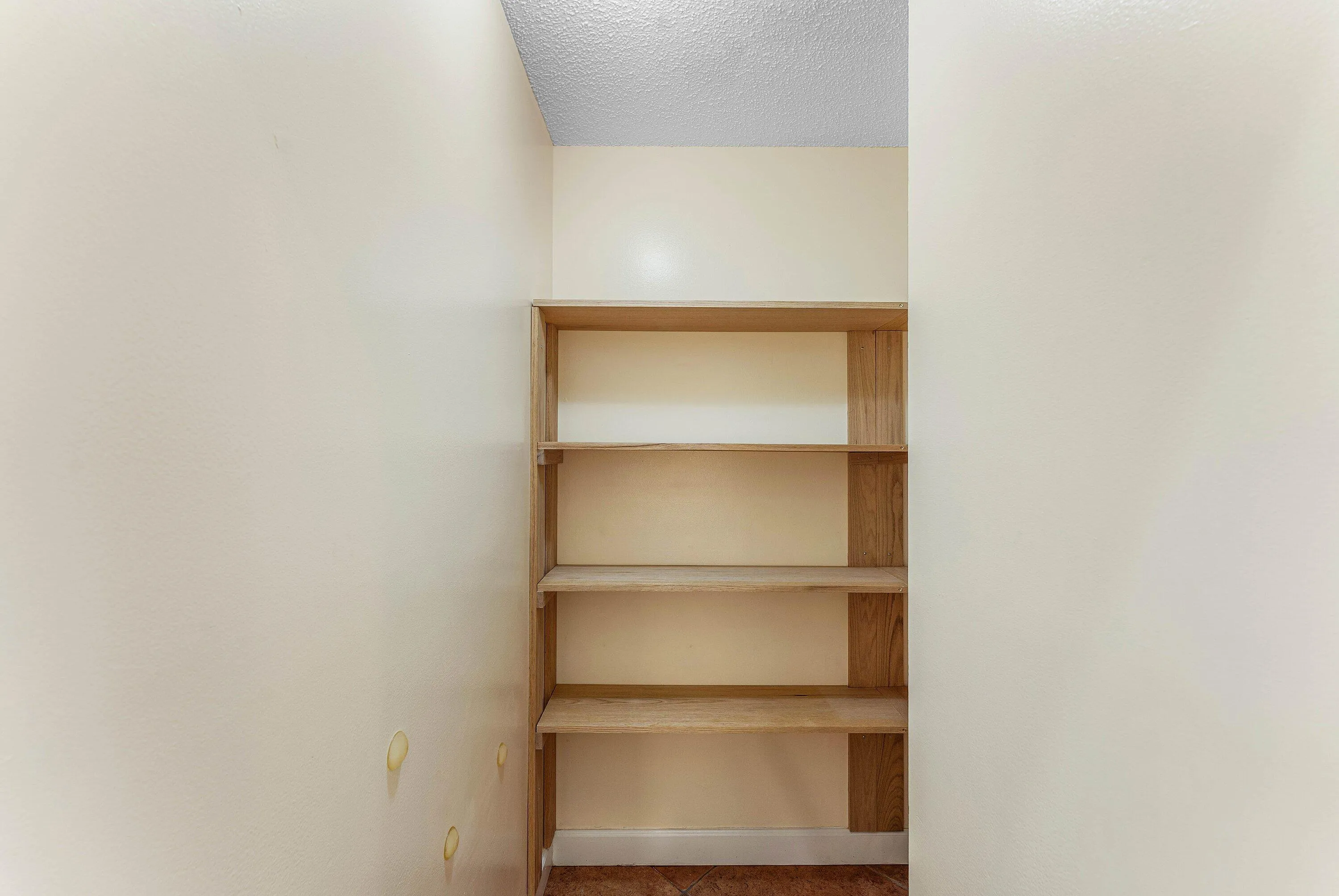 Built-in wooden shelving provides storage space