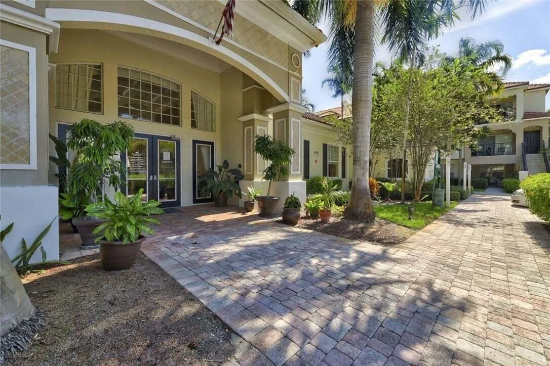 Arched entryway with transom windows, double-door main entrance, and decorative exterior detailing