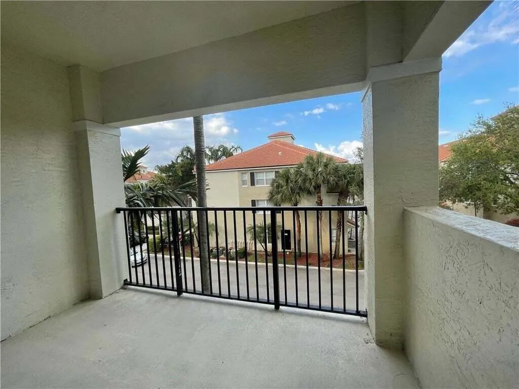 Private balcony with concrete flooring and black metal railings