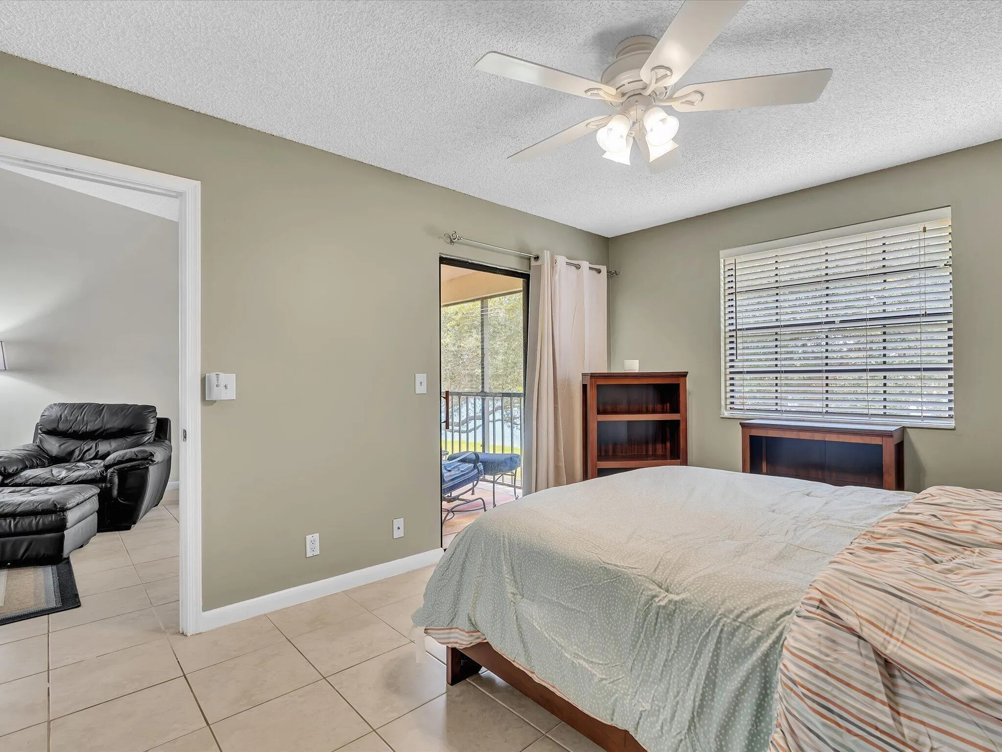 Primary bedroom access to screened in porch