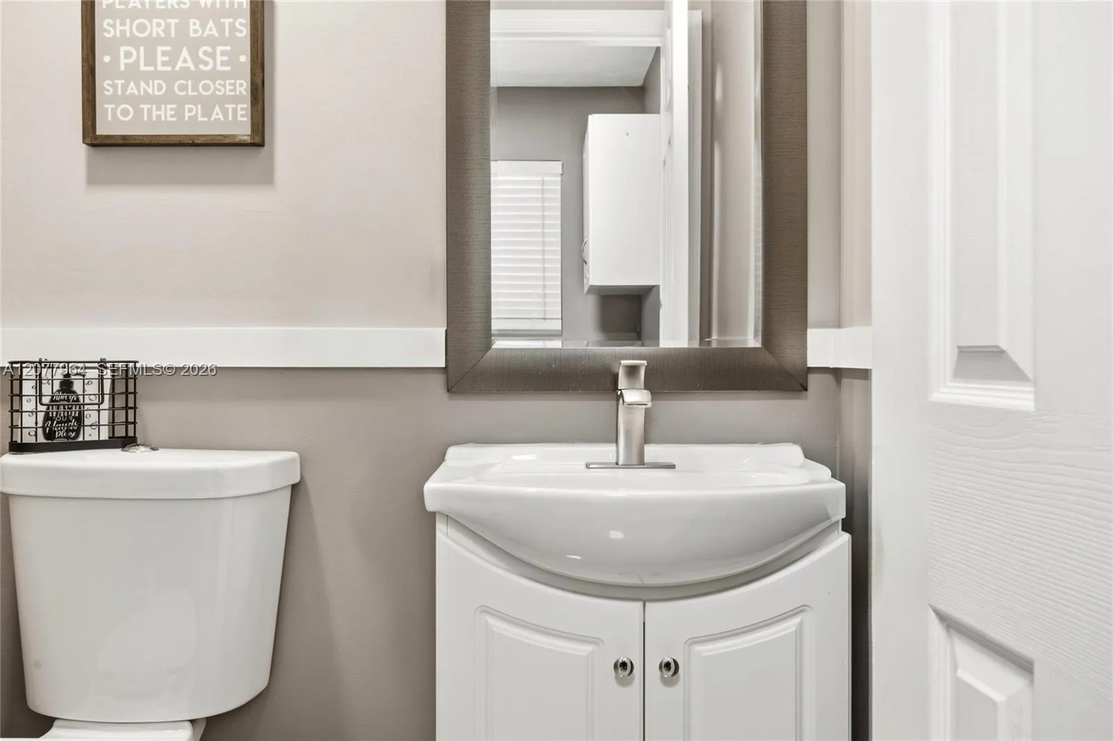 1/2 BATHROOM OFF LAUNDRY ROOM AND FAMILY ROOM