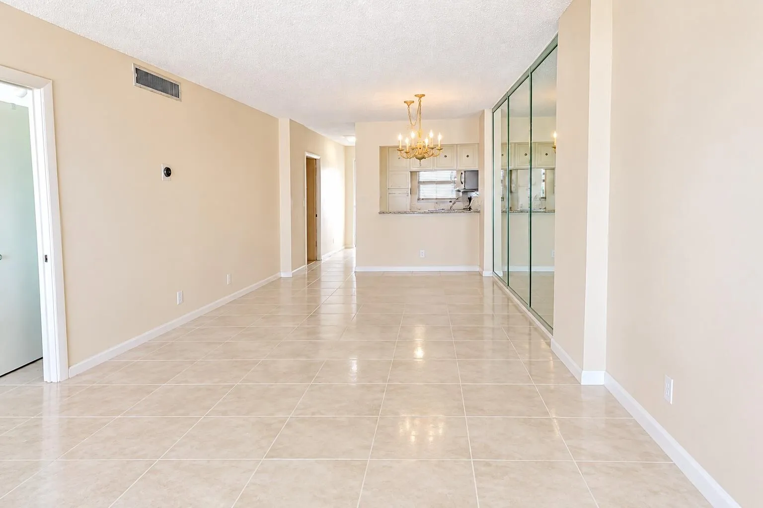 Dining room and living room, furniture removed. Carpet removed, tile added. DIGITALLY ENHANCED