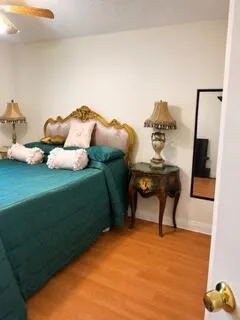 Wood-finish flooring with a ceiling fan overhead