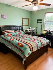 Wood-finish flooring with a ceiling fan light fixture