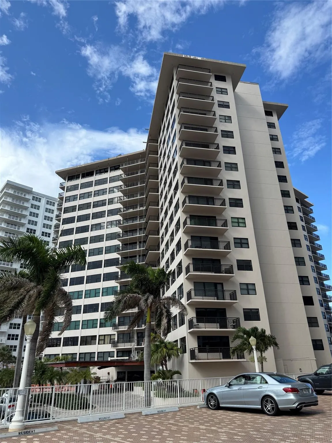 Multi-story residential building with private balconies and exterior lighting fixtures