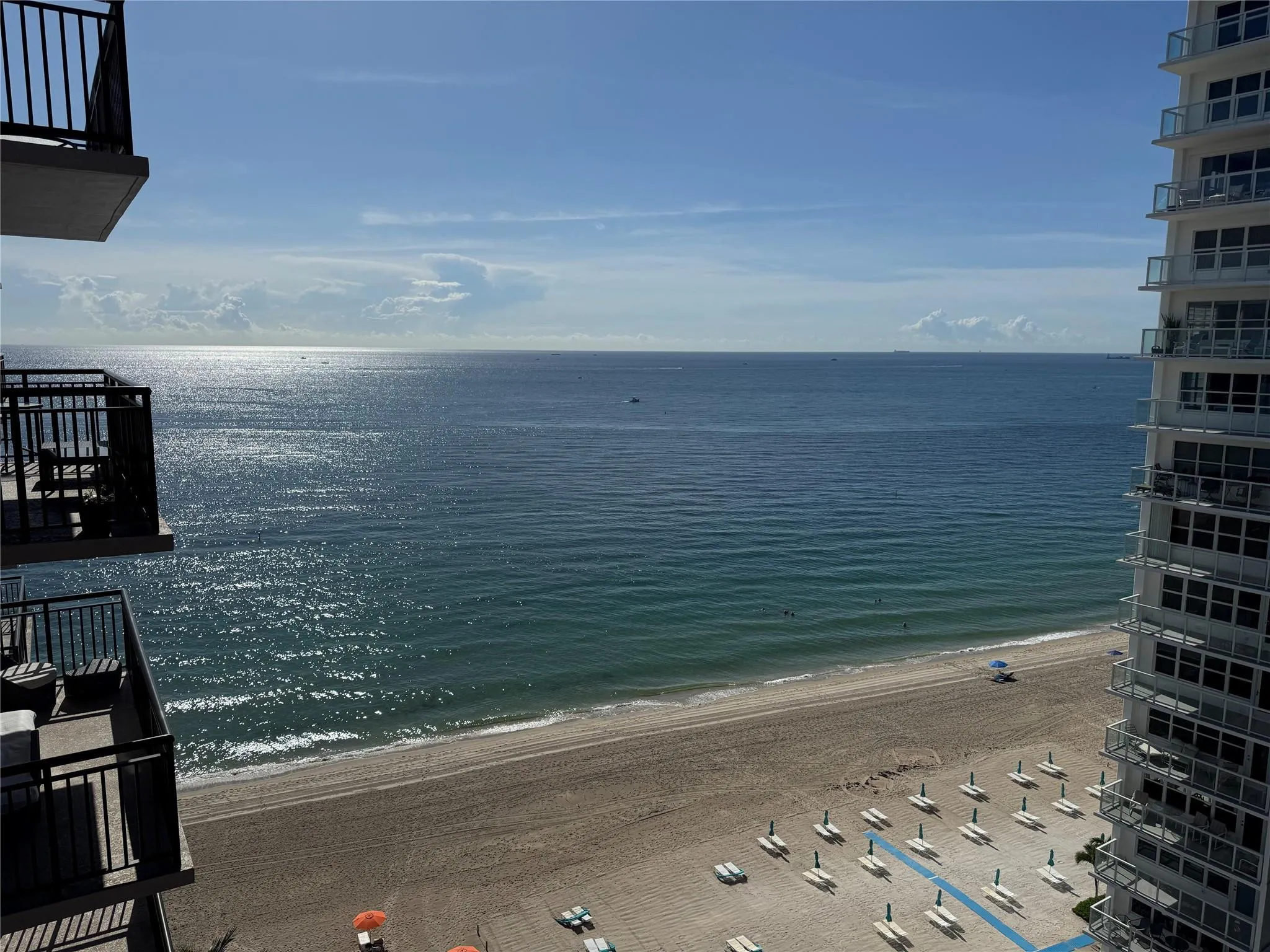Expansive oceanfront balcony with metal railings