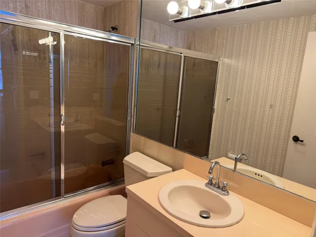 Built-in vanity with an oval sink and a chrome faucet