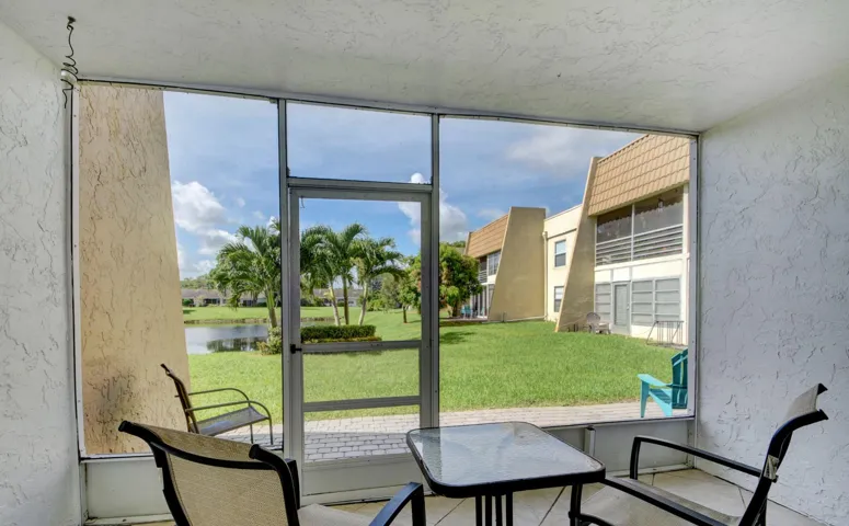 Screened-in patio with textured walls, providing outdoor living space