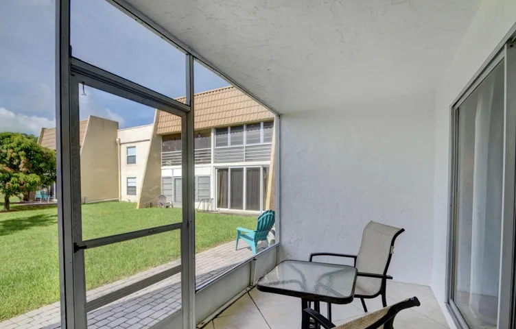 Screened patio with tiled flooring