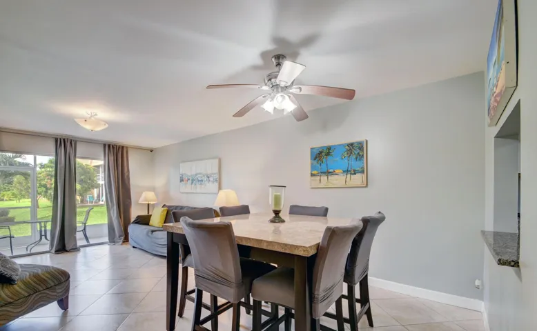 Tiled flooring throughout, ceiling fan with integrated lighting, and a pass-through opening