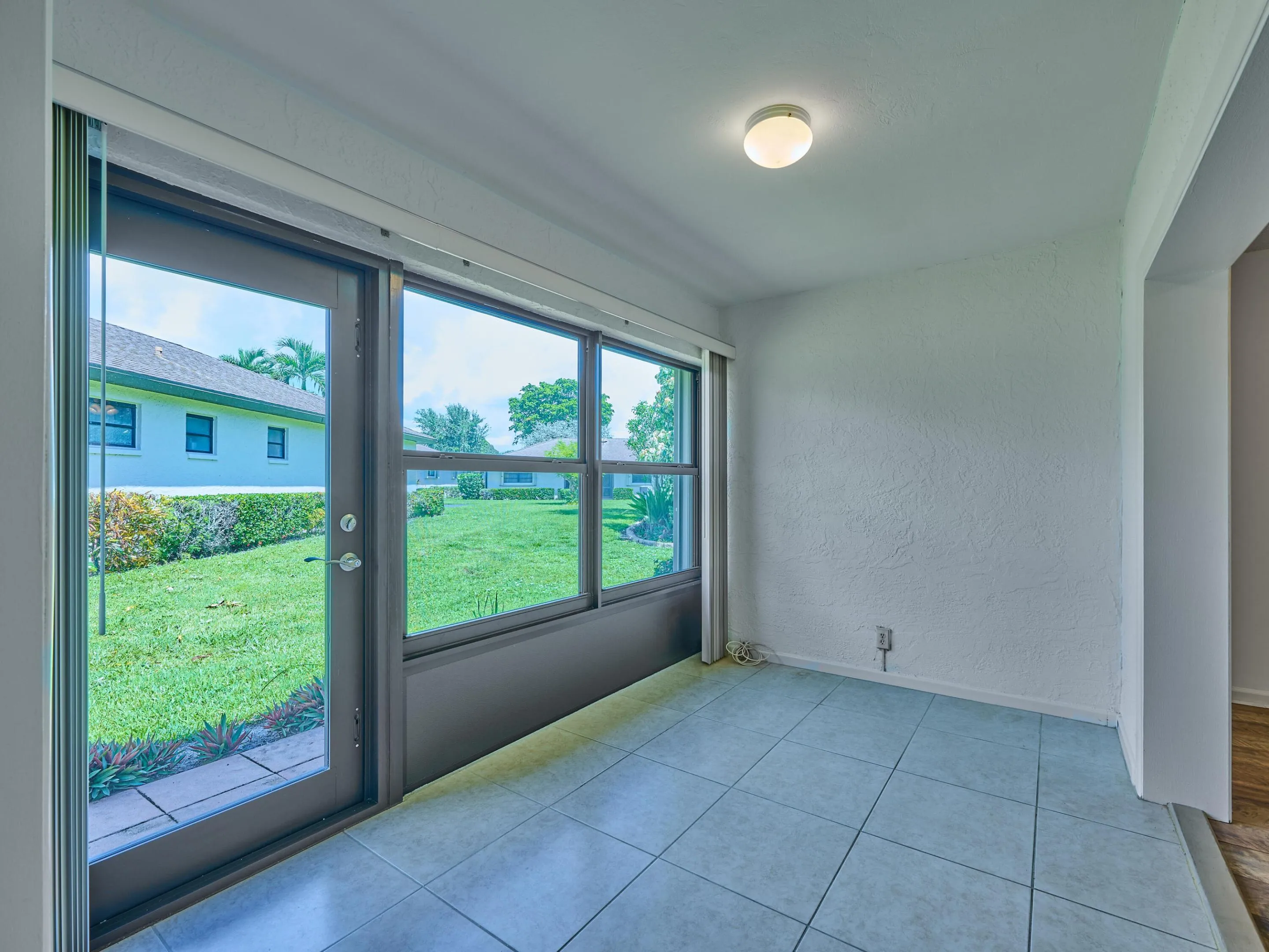 Rear enclosed porch with Wind and storm rated exterior door and windows