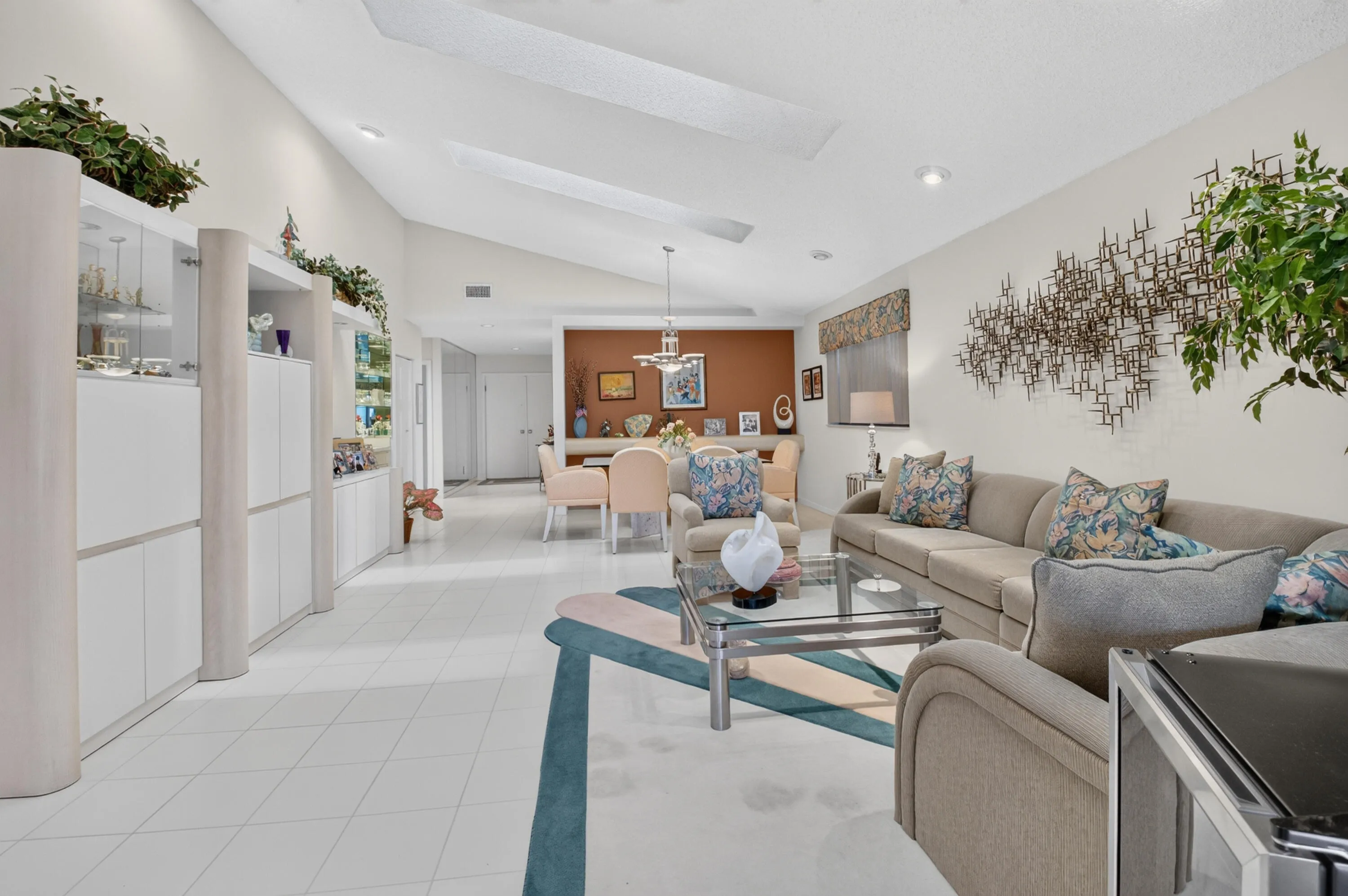 Vaulted ceilings with skylights, extensive built-in cabinetry, tile flooring, recessed lighting, and a defined dining area