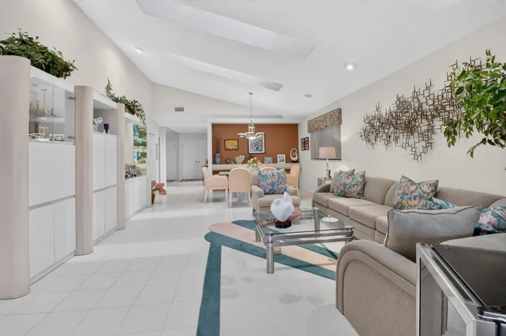 Vaulted ceilings with skylights, extensive built-in cabinetry, tile flooring, recessed lighting, and a defined dining area
