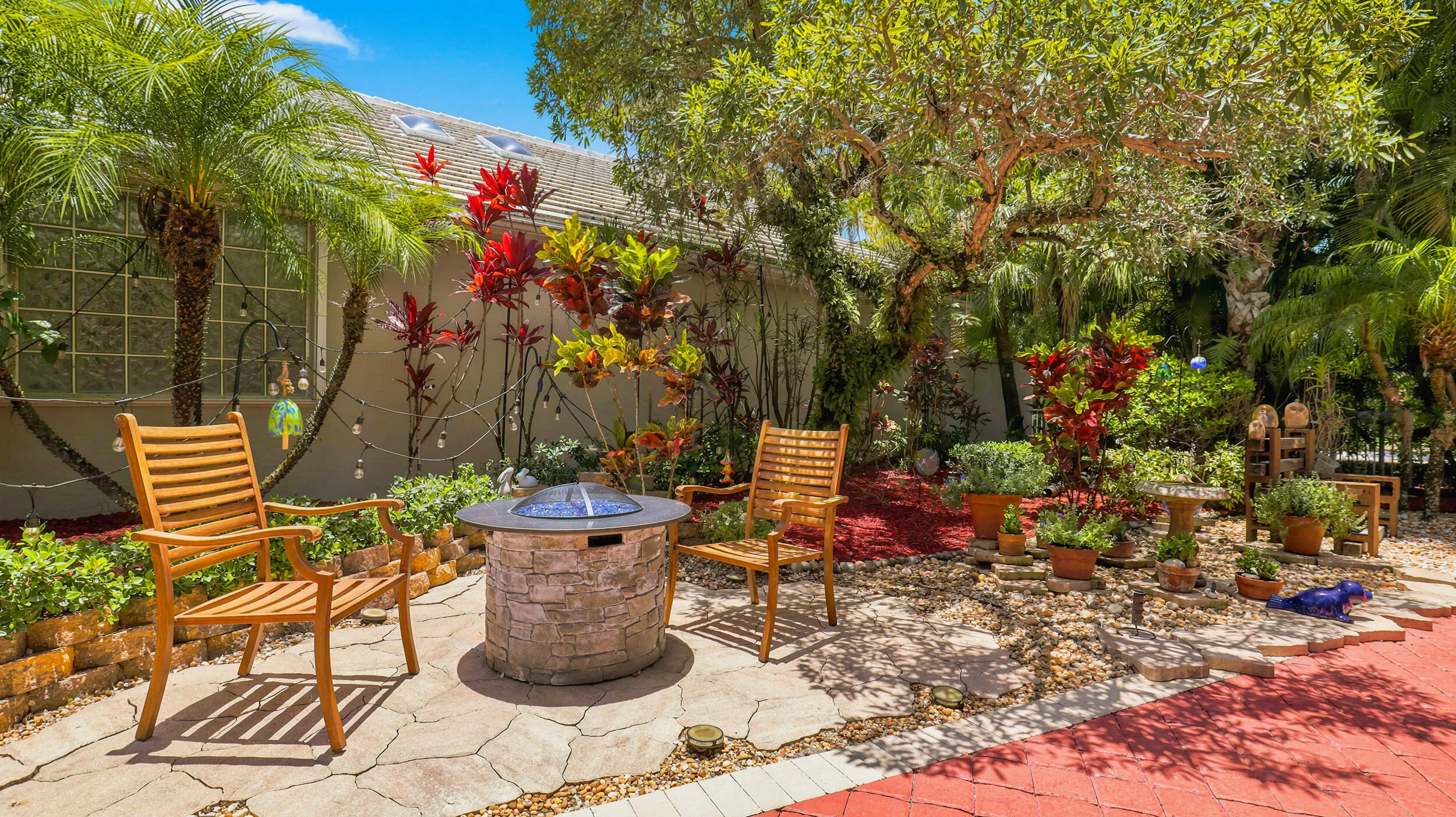 Private garden setting with mature tropical landscaping and a cozy outdoor gathering area.