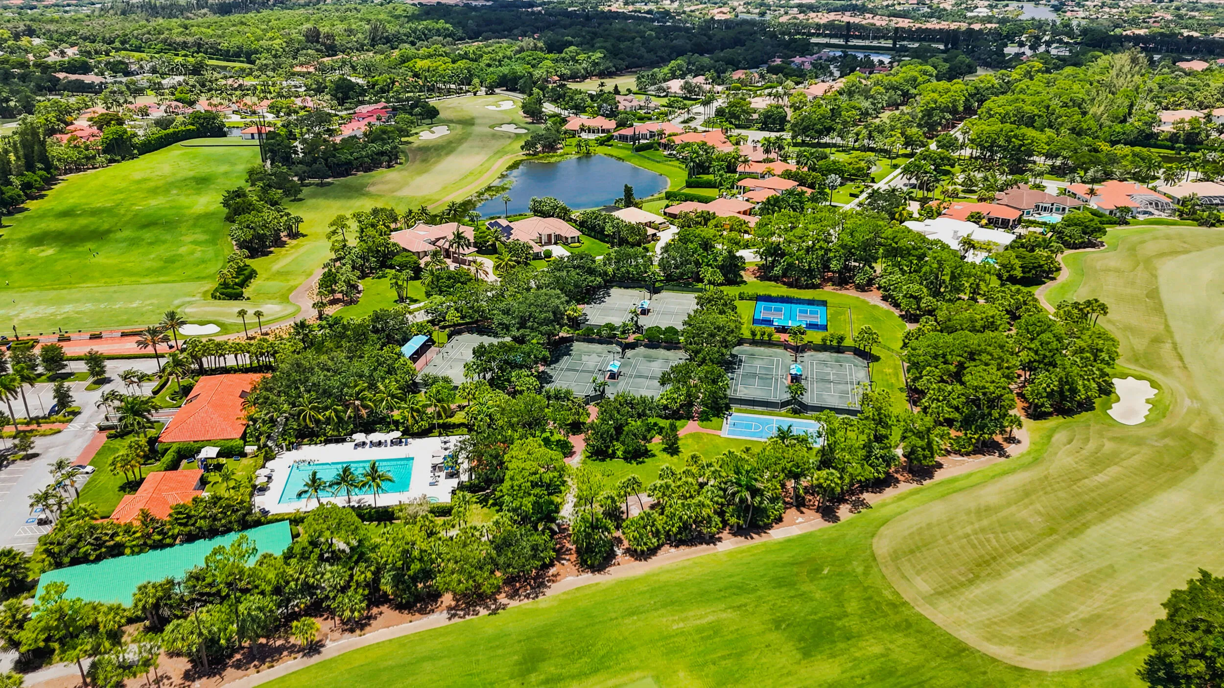 Elevated aerial perspective highlighting the golf course, water features, and surrounding residential community.