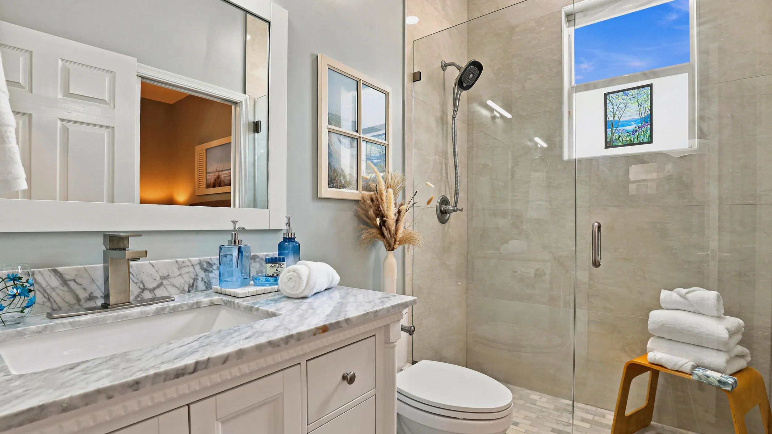 Updated full bathroom featuring a spacious vanity and glass-enclosed tiled shower
