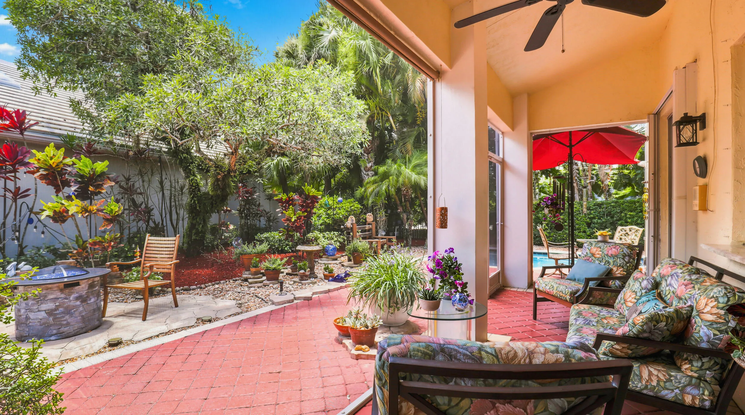 Inviting covered patio with comfortable seating and peaceful views of the landscaped backyard.