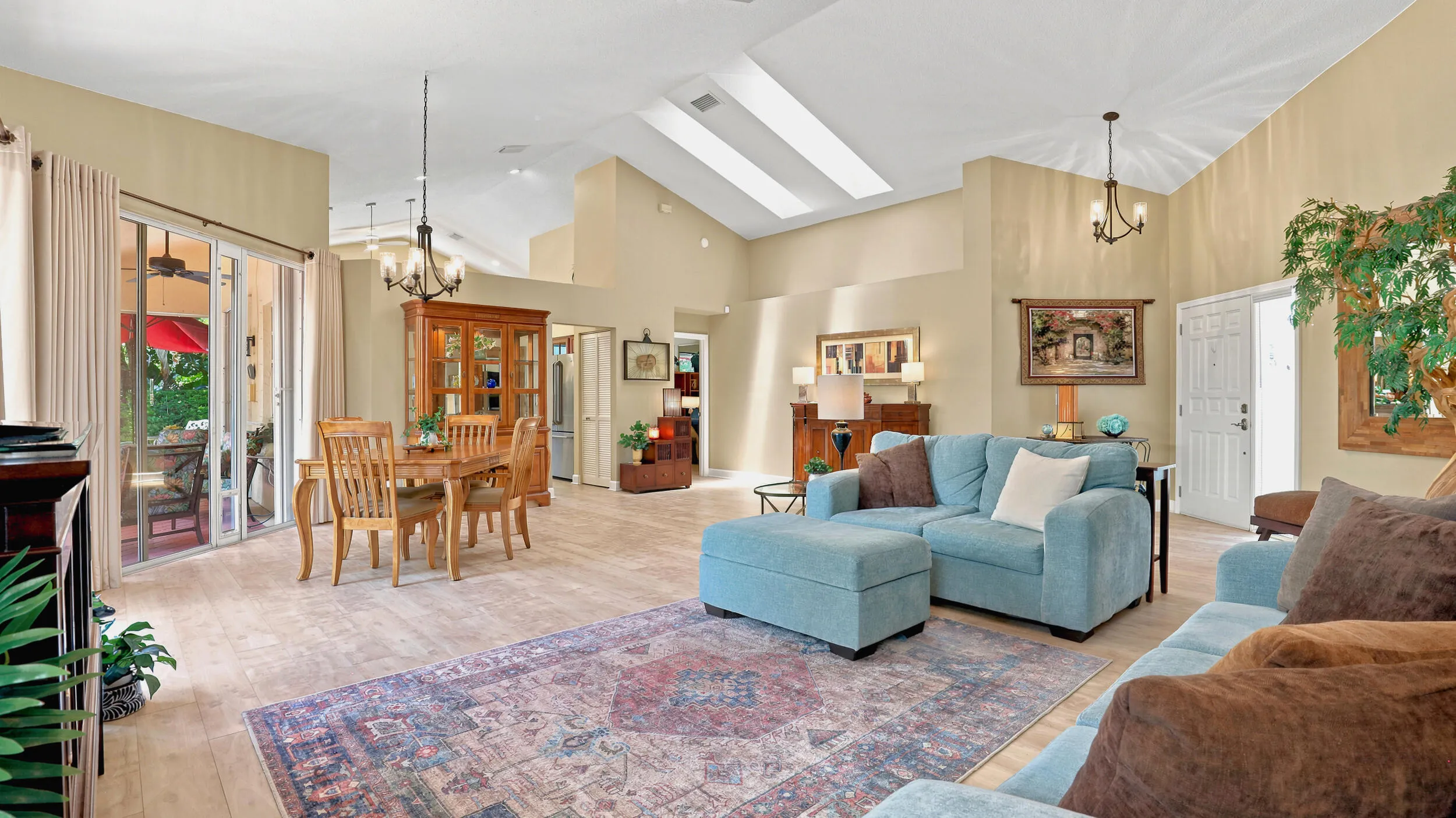 Wide interior view showcasing the living room, dining area, and open flow of the home.