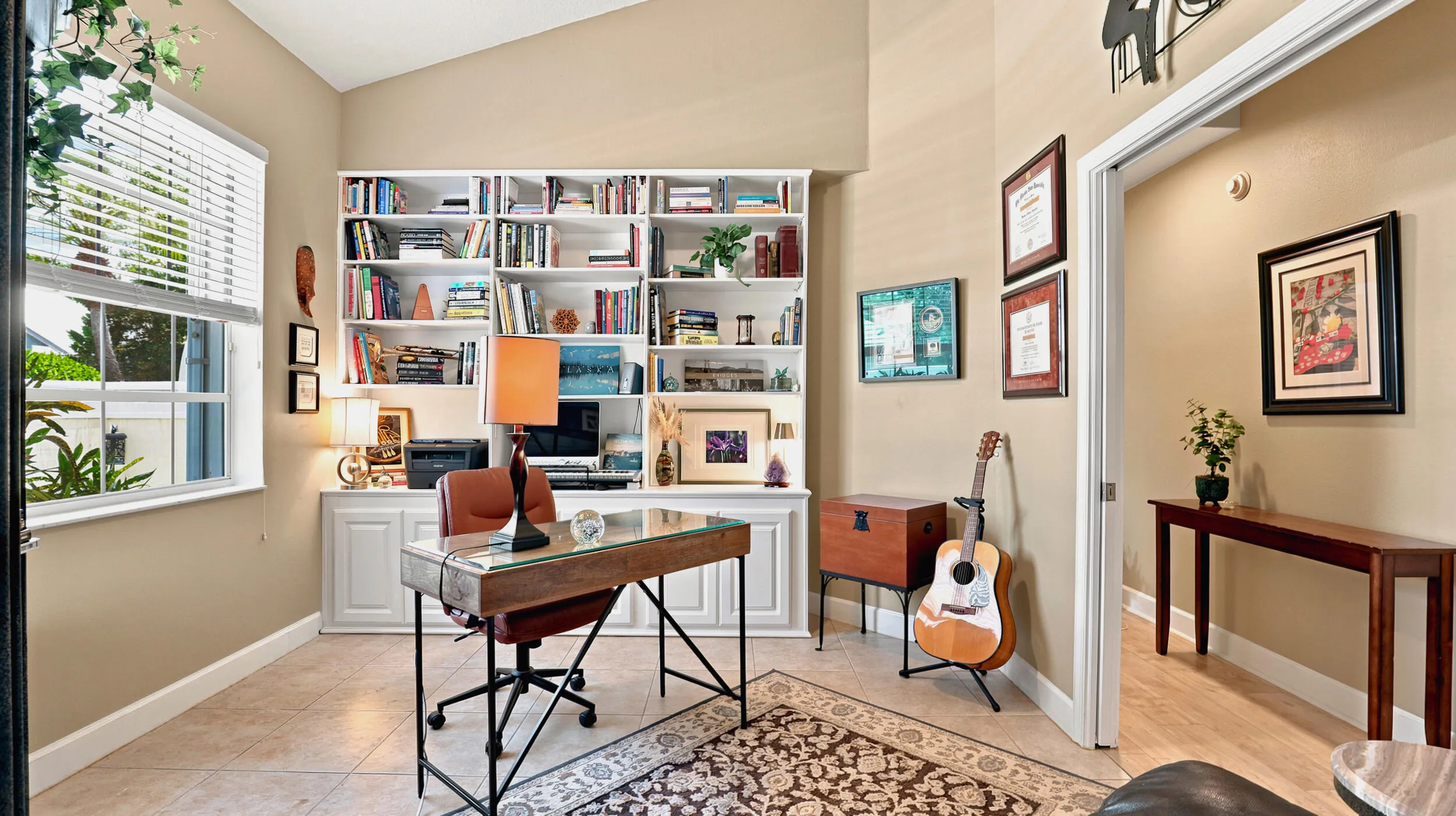 Bright home office featuring custom built-ins, generous storage, and room for a full-size desk.