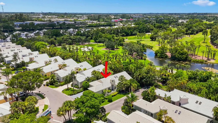 Wide aerial view showcasing the home, surrounding neighborhood, and nearby recreational areas.