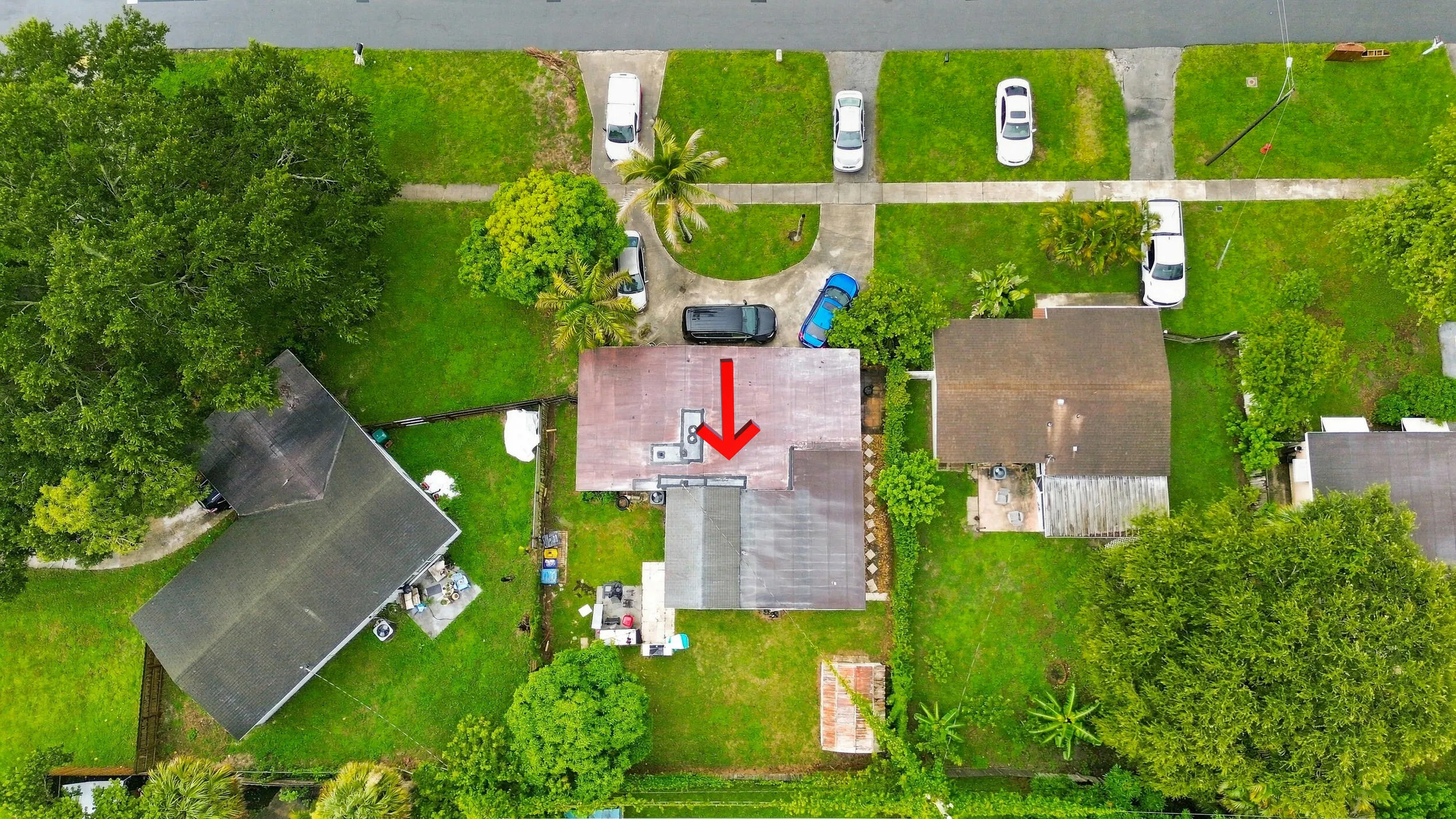 Direct aerial view highlighting the home, lot, backyard, driveway, and neighboring properties.