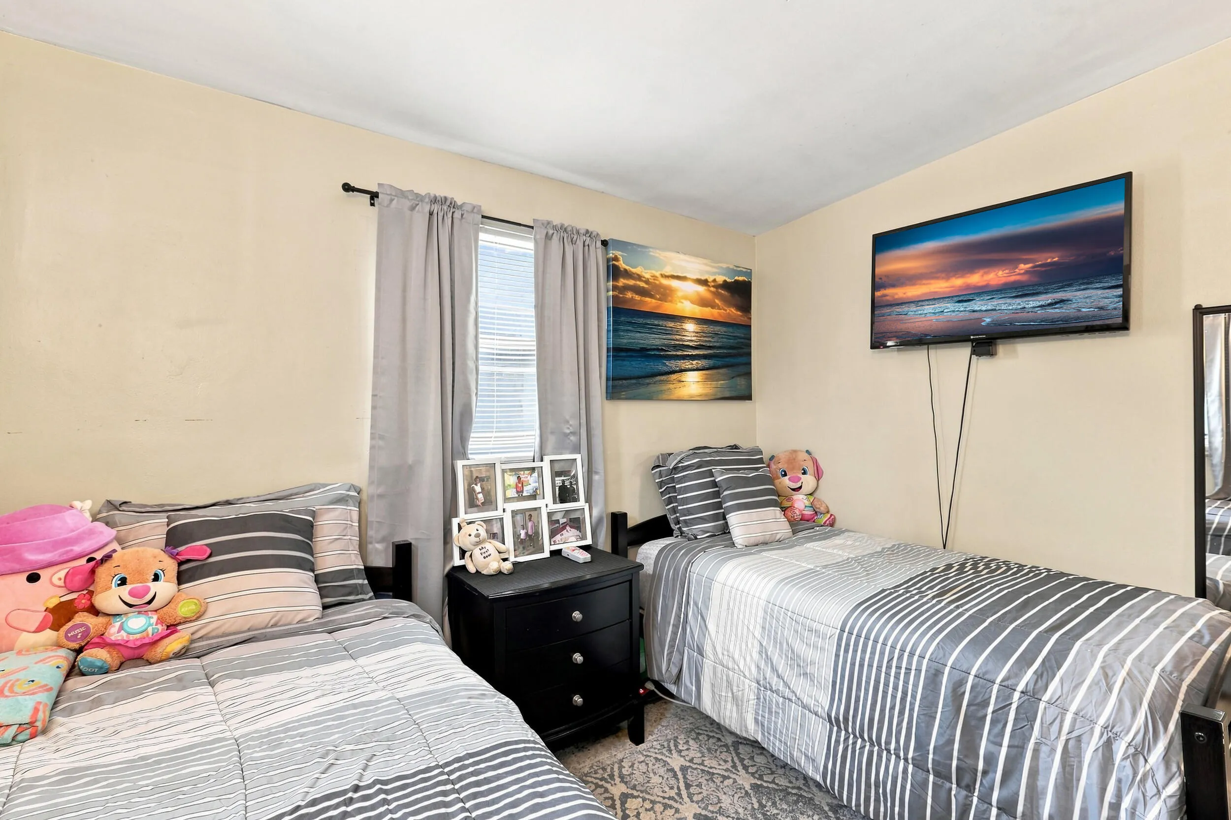 Comfortable secondary bedroom with natural light and neutral finishes.