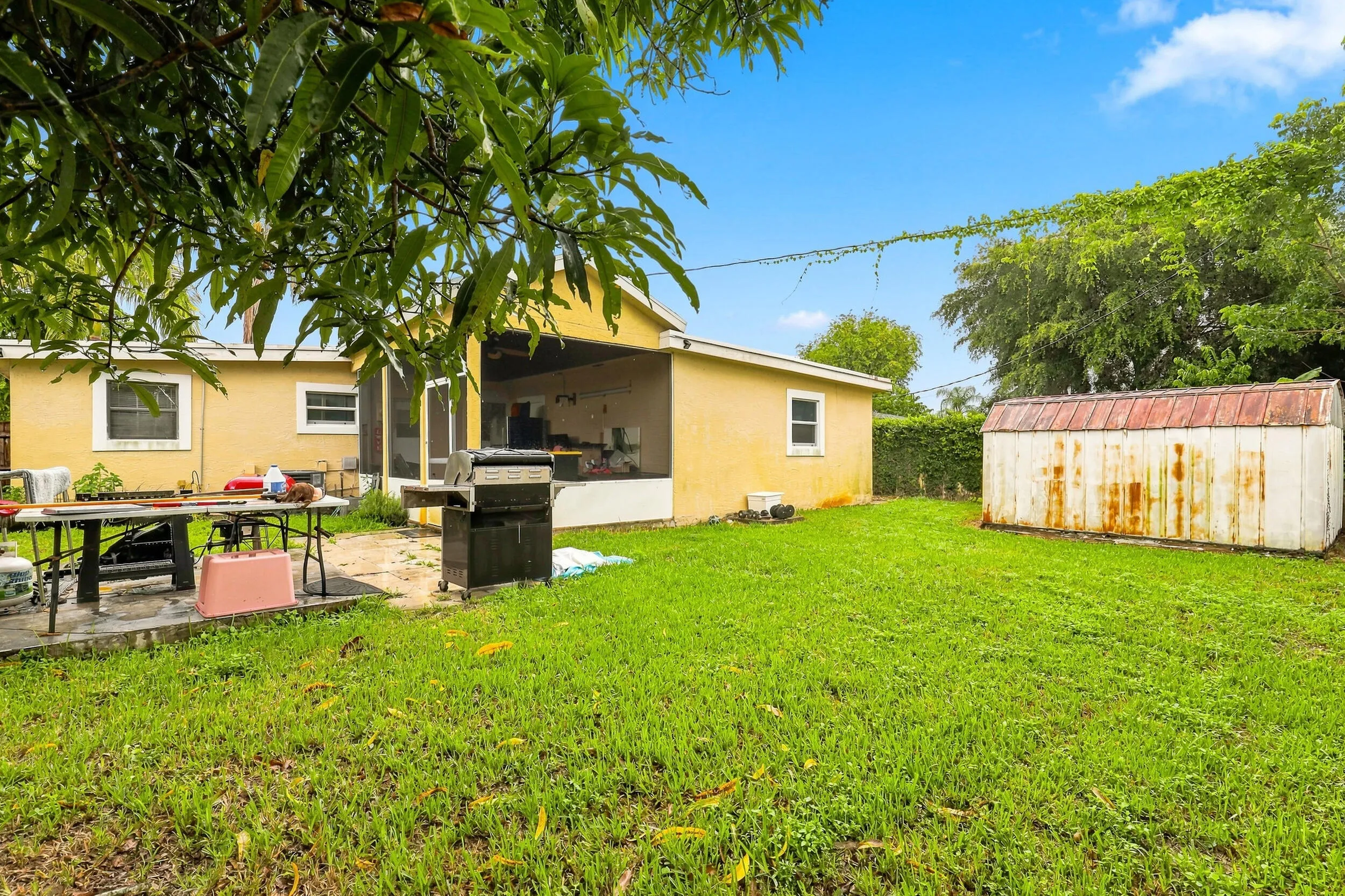 Additional rear view highlighting the spacious yard and outdoor living area.