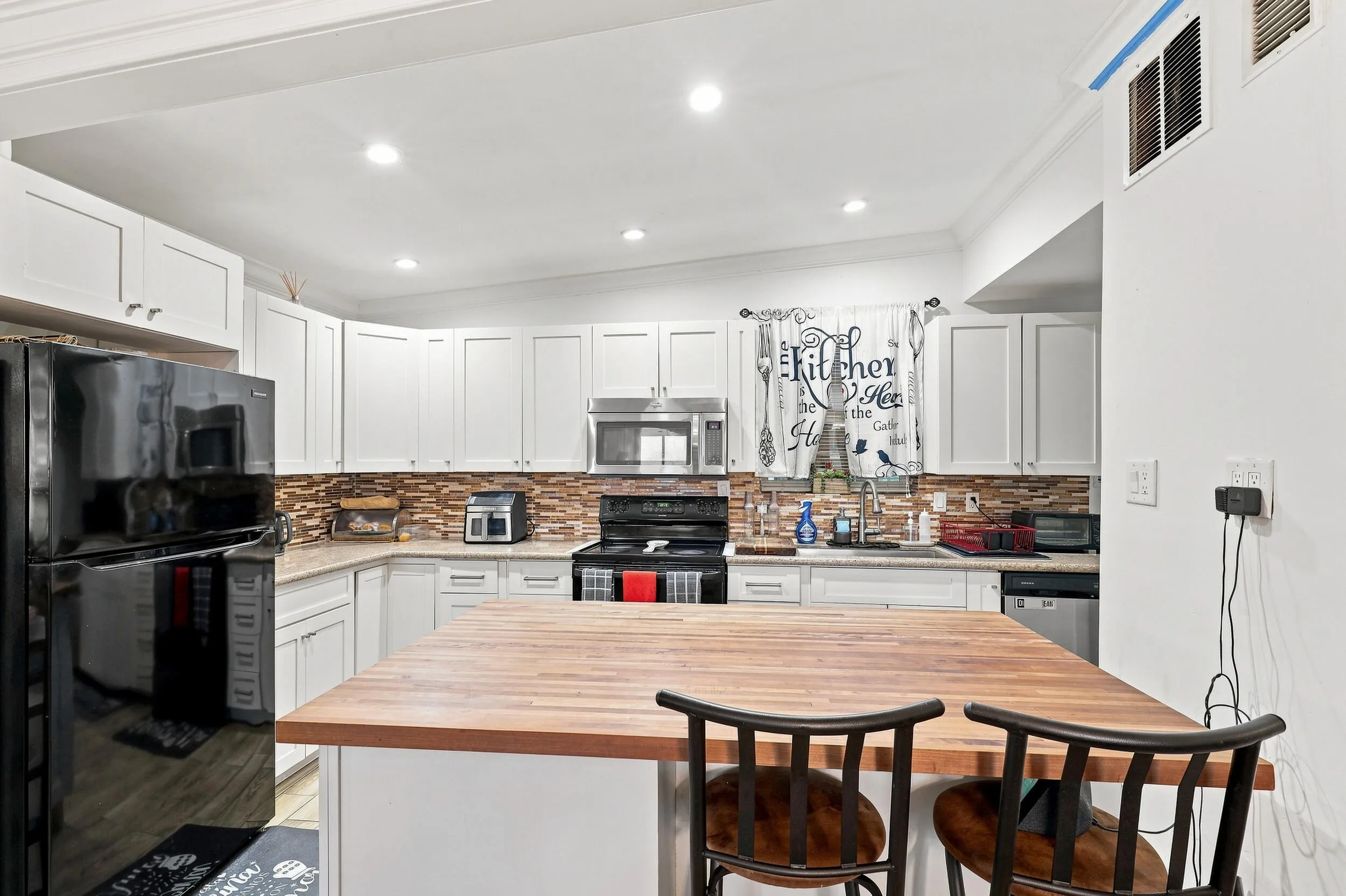 Spacious kitchen with generous cabinetry, center island with seating, and an open layout for everyday living.