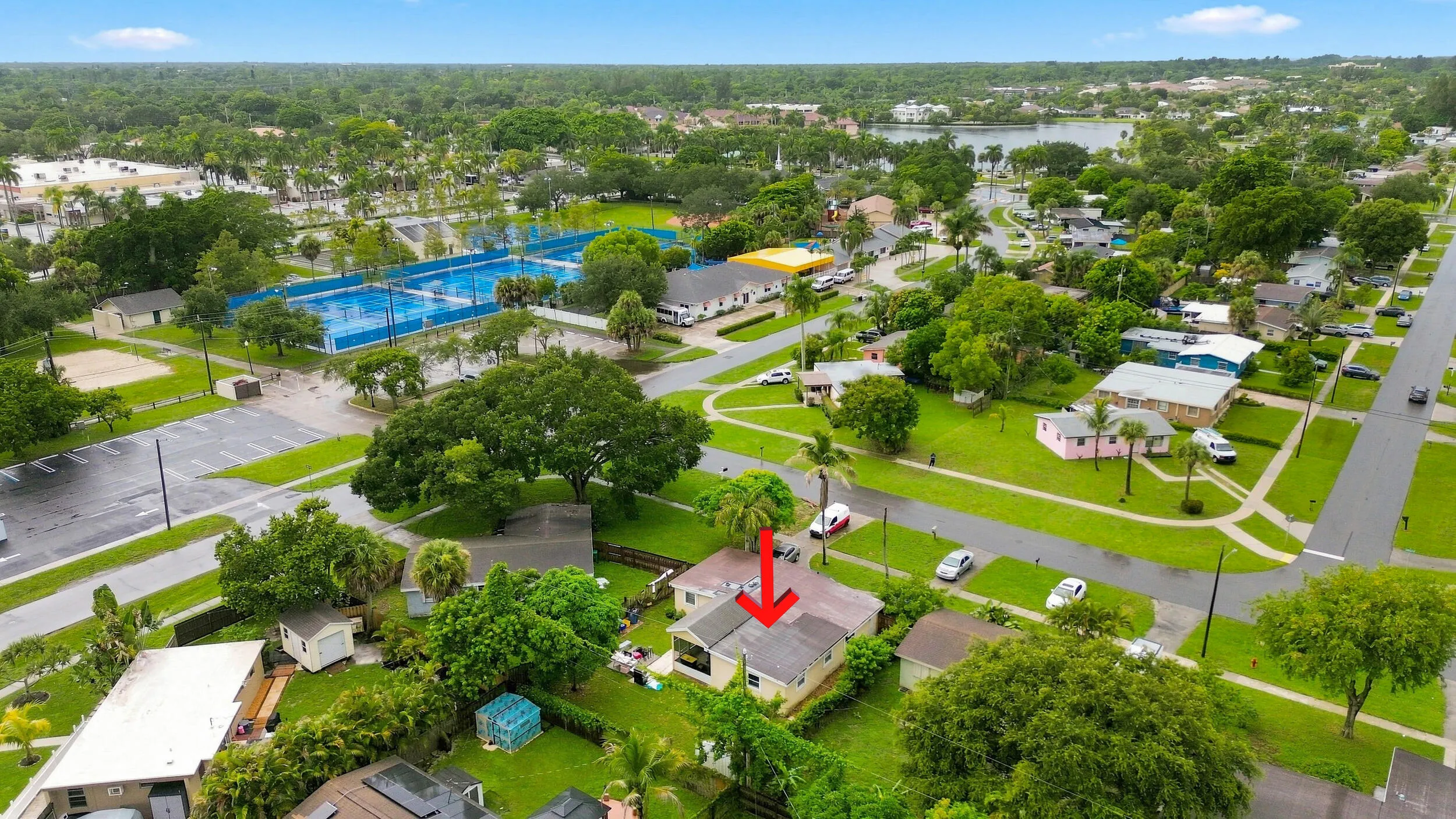 Expansive aerial view showcasing the property, surrounding neighborhood, and nearby community amenities.