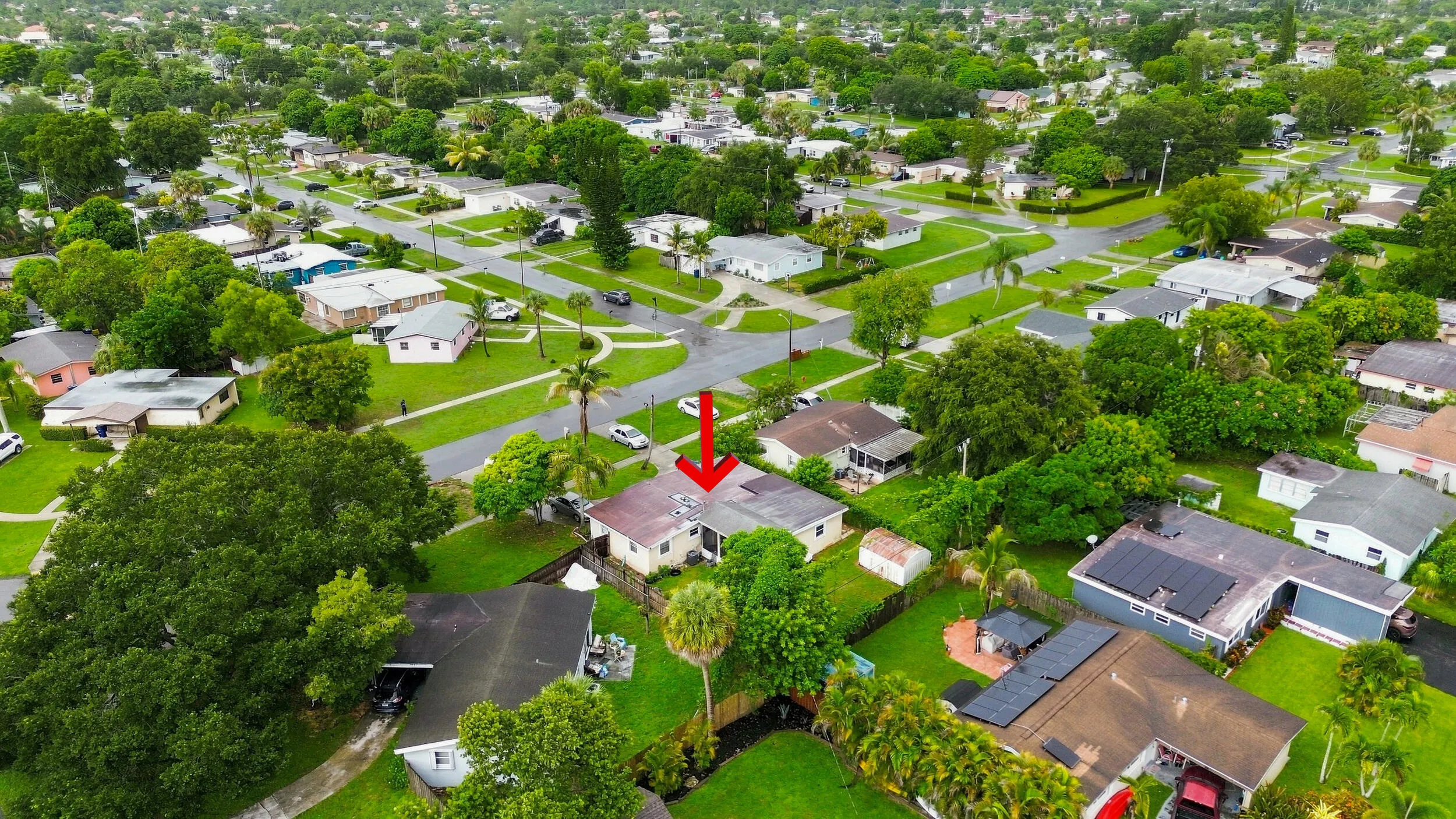 Wide aerial perspective highlighting the property within the established neighborhood.