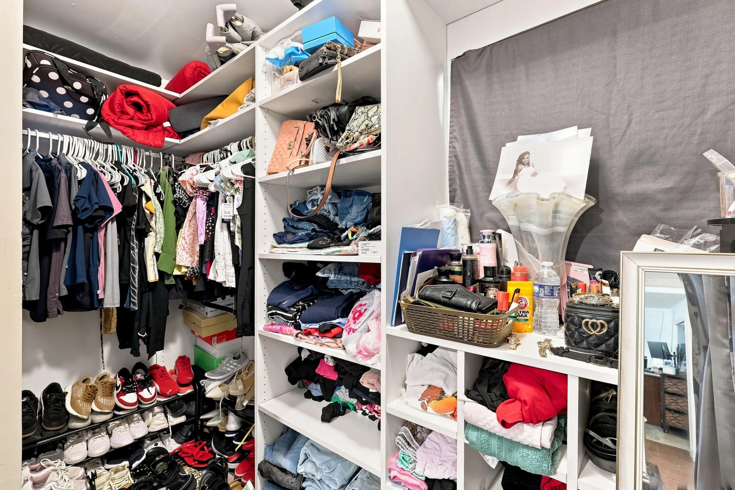 Generous walk-in closet with built-in shelving, hanging space, and plenty of storage.