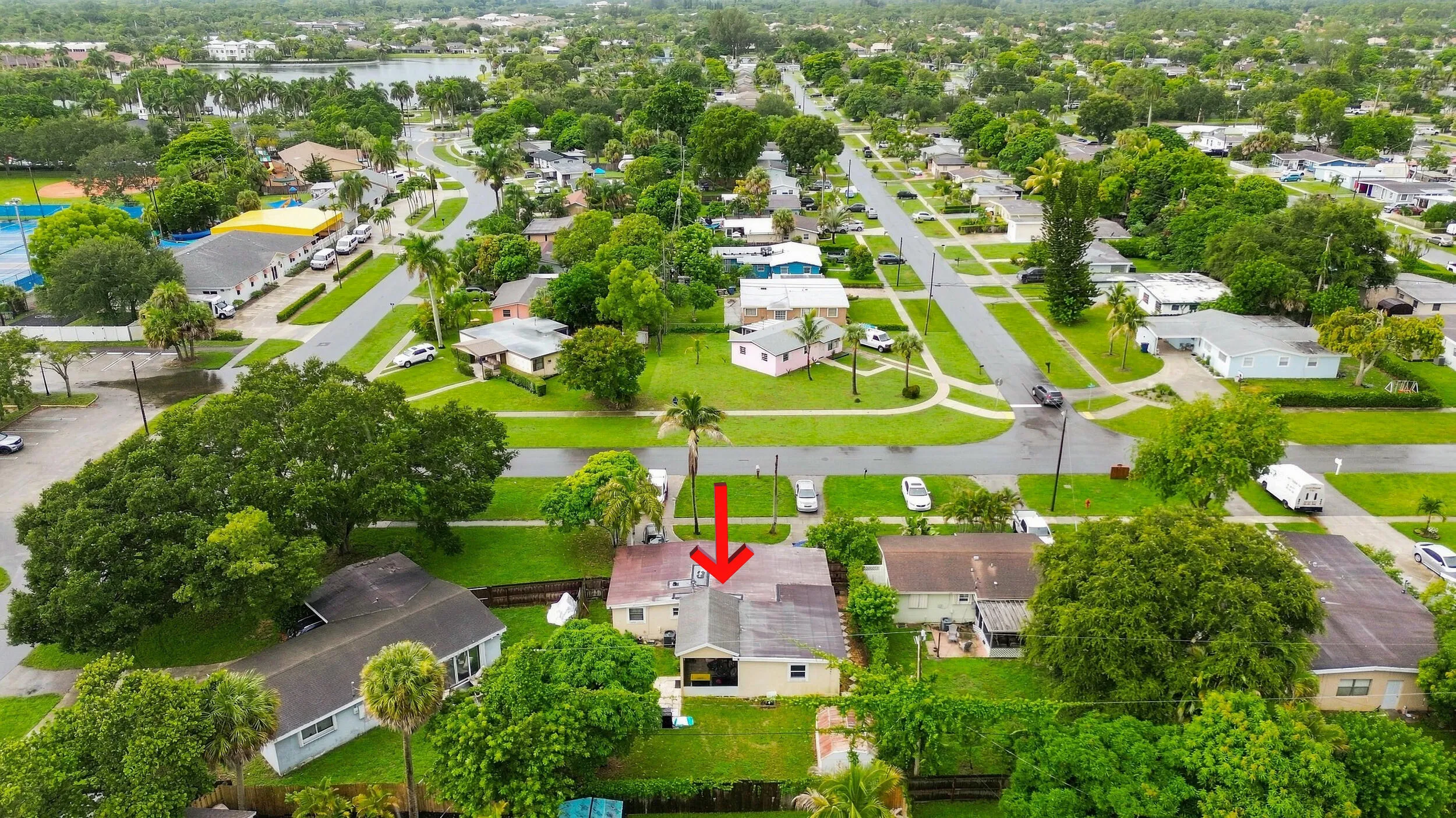 Elevated view showcasing the home, lot, and surrounding residential community.