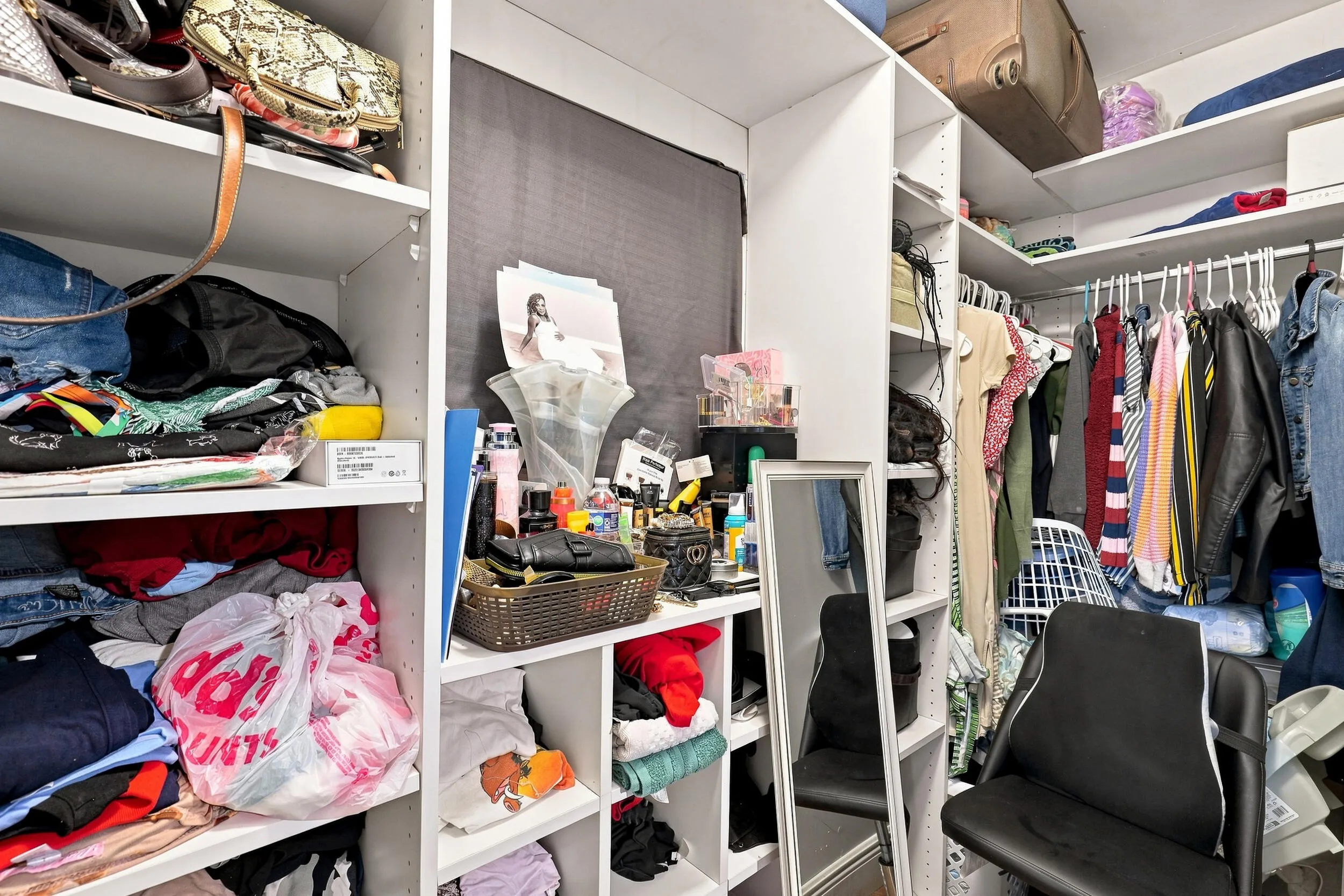 Additional closet view showcasing extensive shelving and organized storage space.