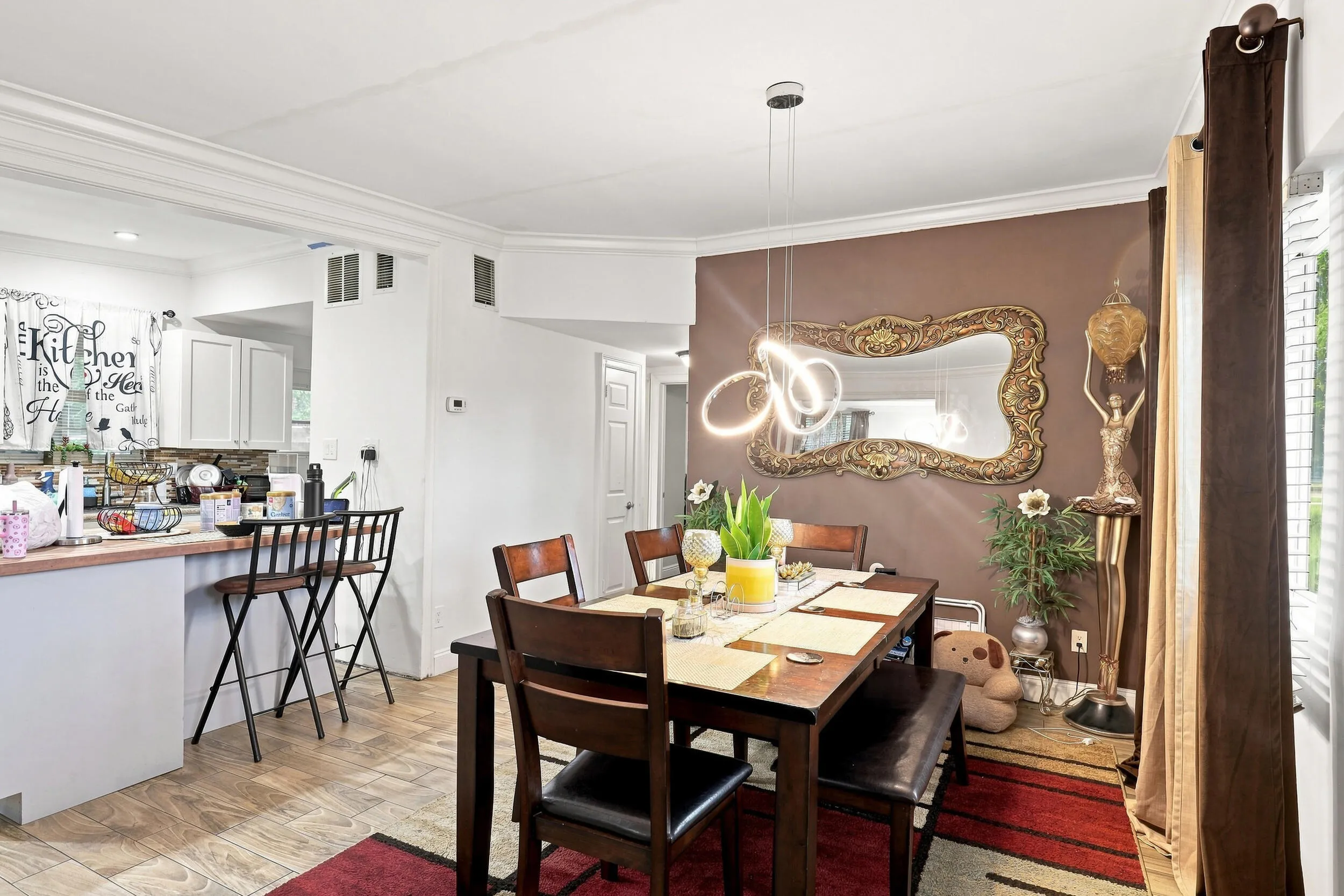 Comfortable dining space with modern flooring and an open connection to the kitchen and living areas.
